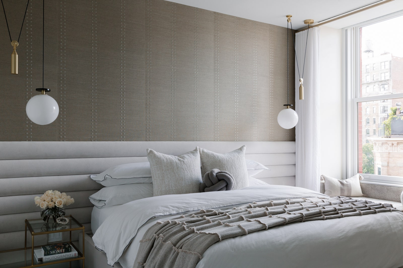 Grey bedroom with bed hanging lights and window