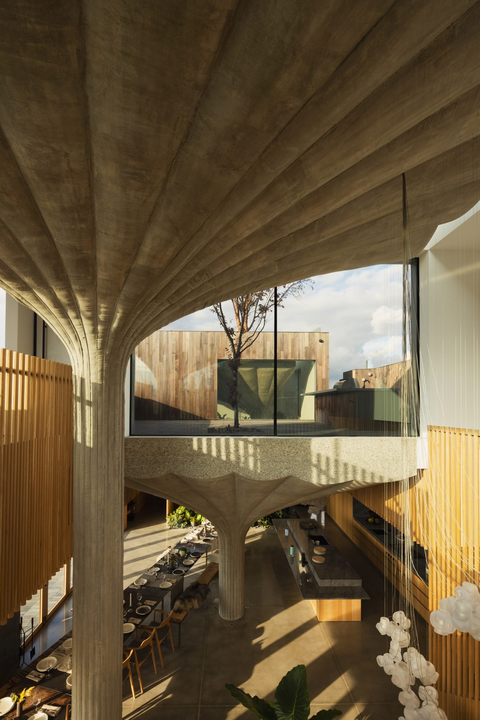 A double height space with concrete pillars