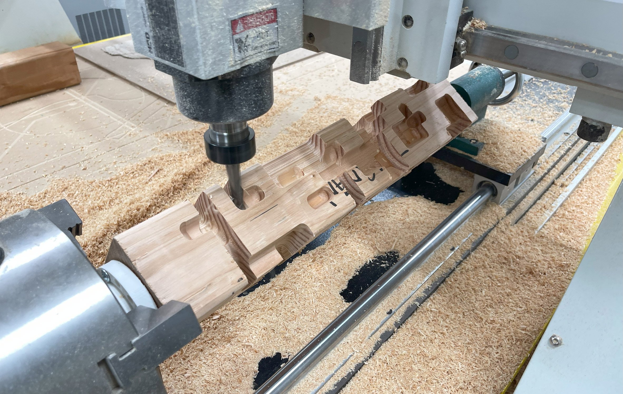 Photograph of a design tool carving a wooden block