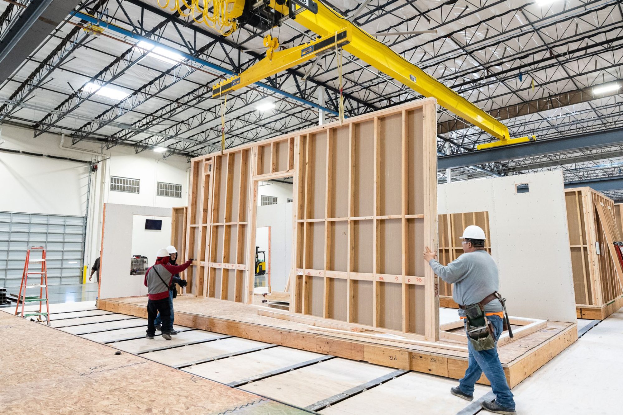 two construction workers at modular construction factory