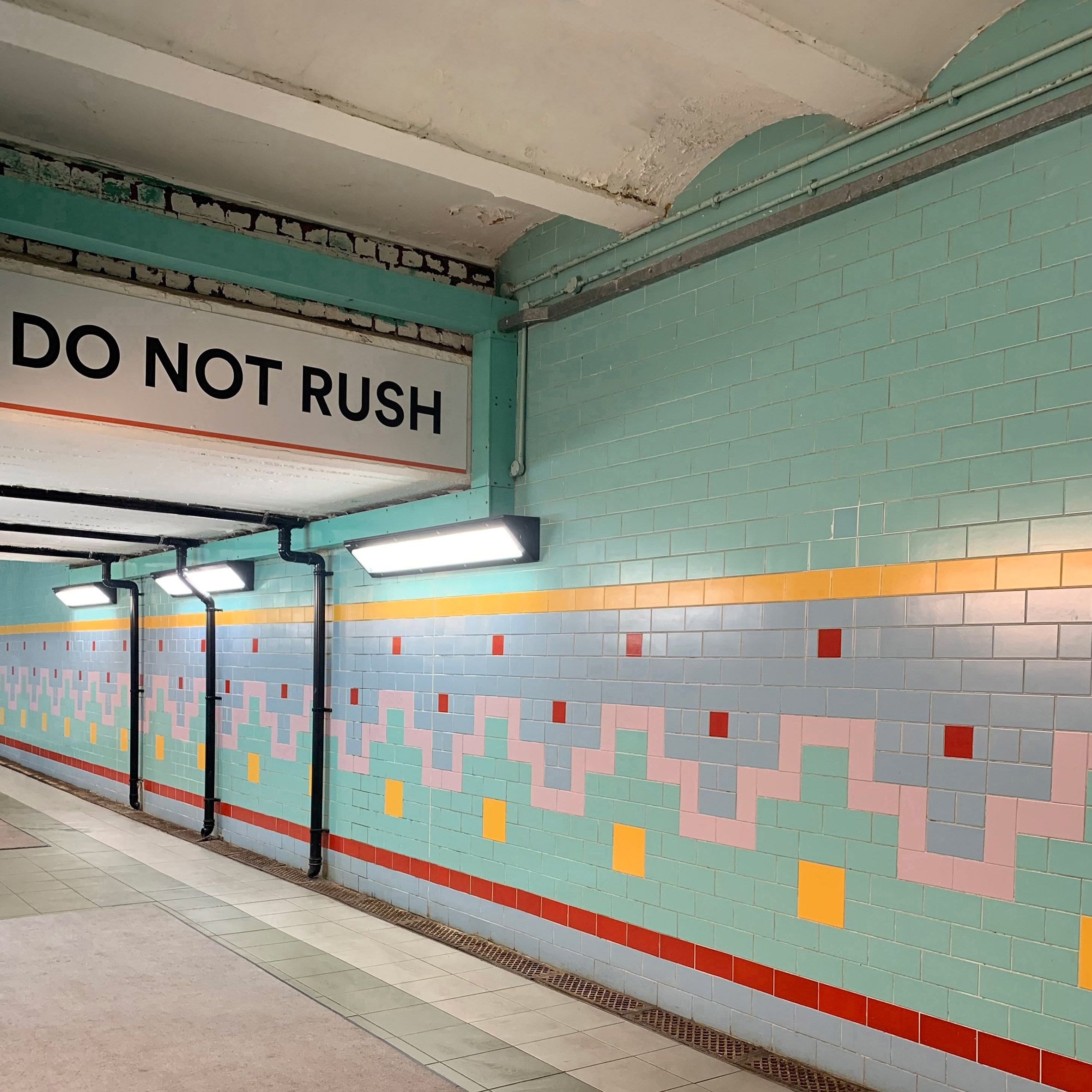 Do Not Rush sign at railway station 