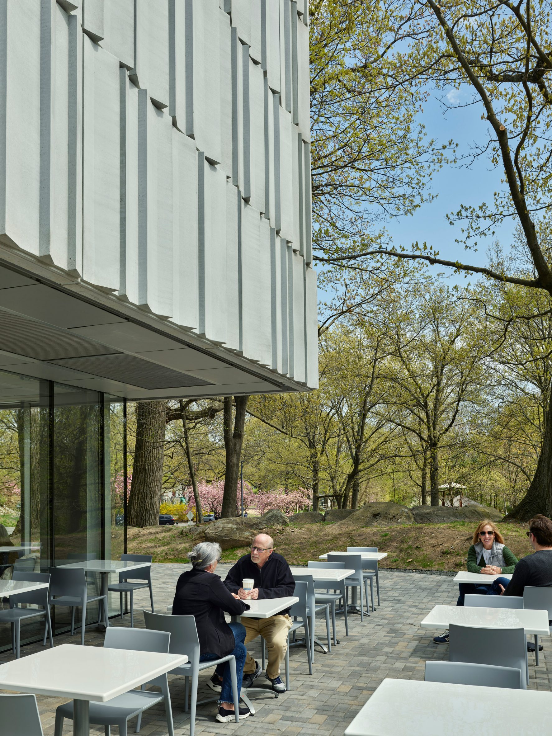 People sitting outside underneath a museum
