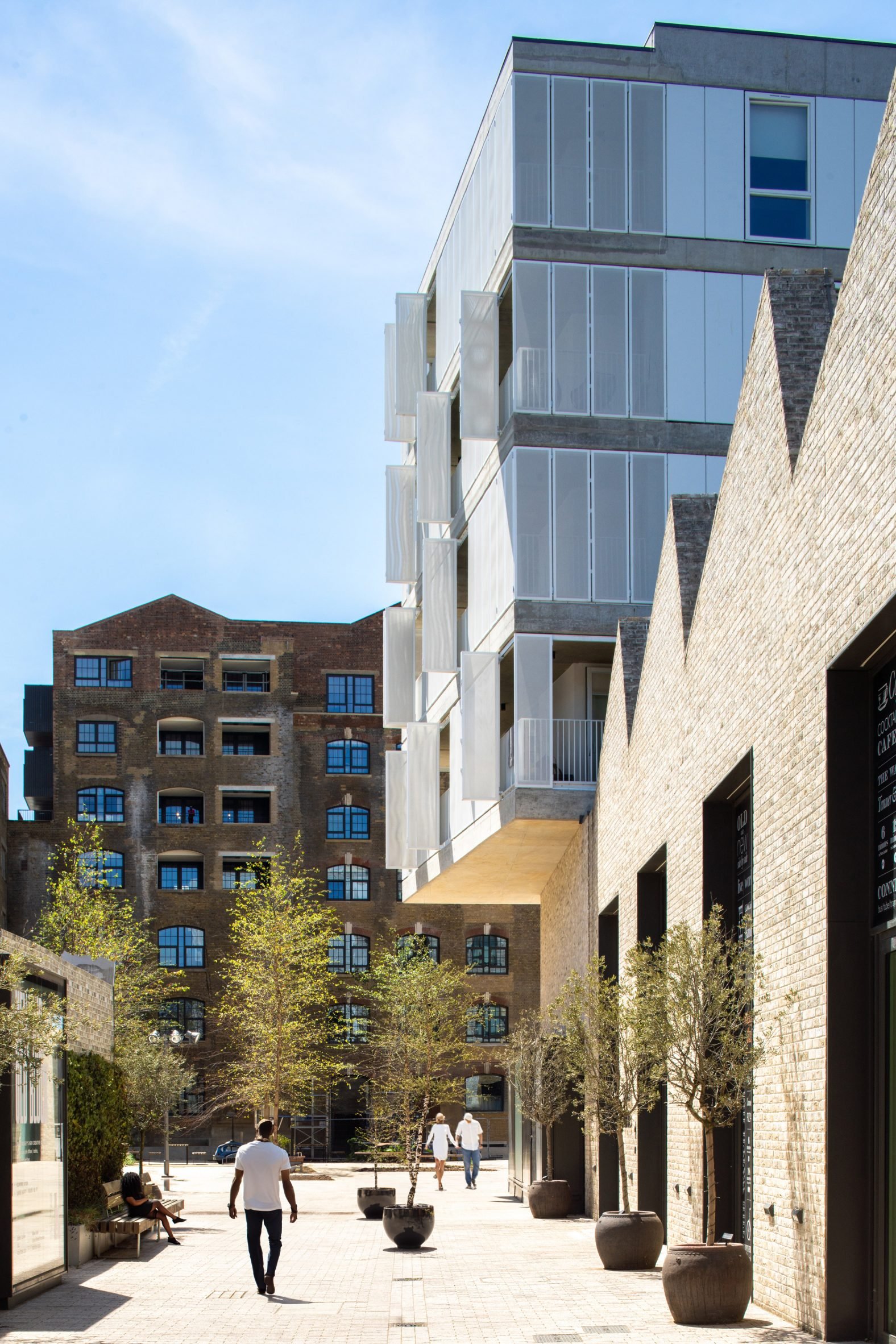 Brick housing and arts building with a saw tooth roof by Coffey Architects