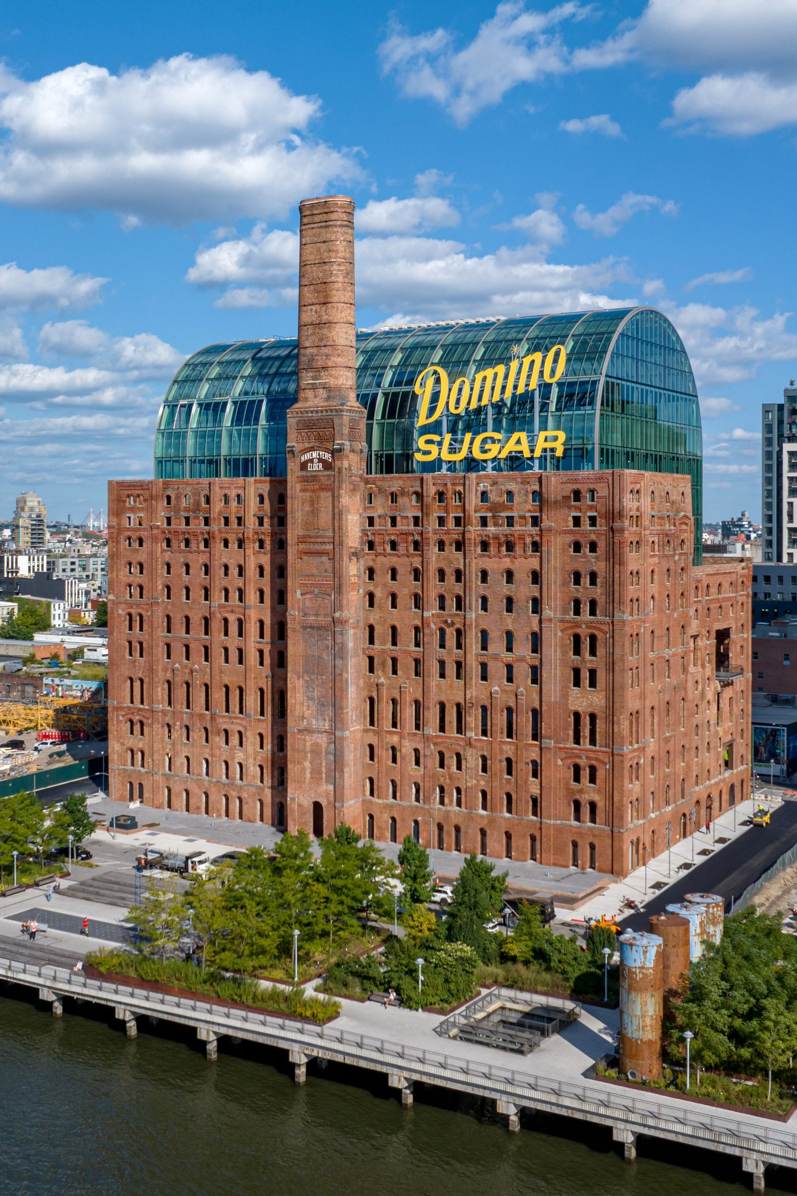 Building with historical brick facade wrapping new glass building
