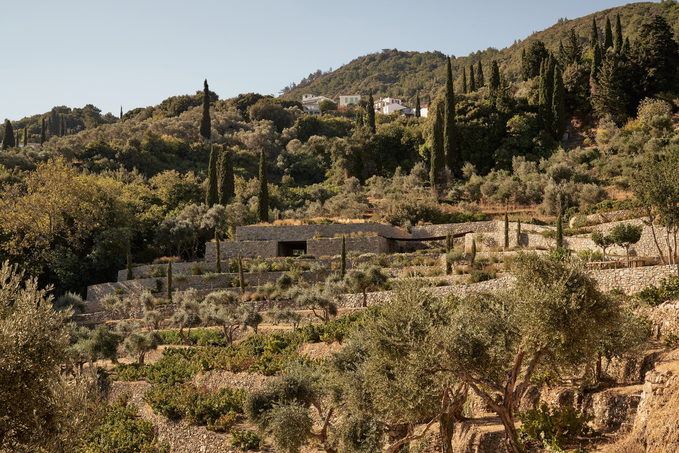 Liknon stone building on a hillside by K-studio