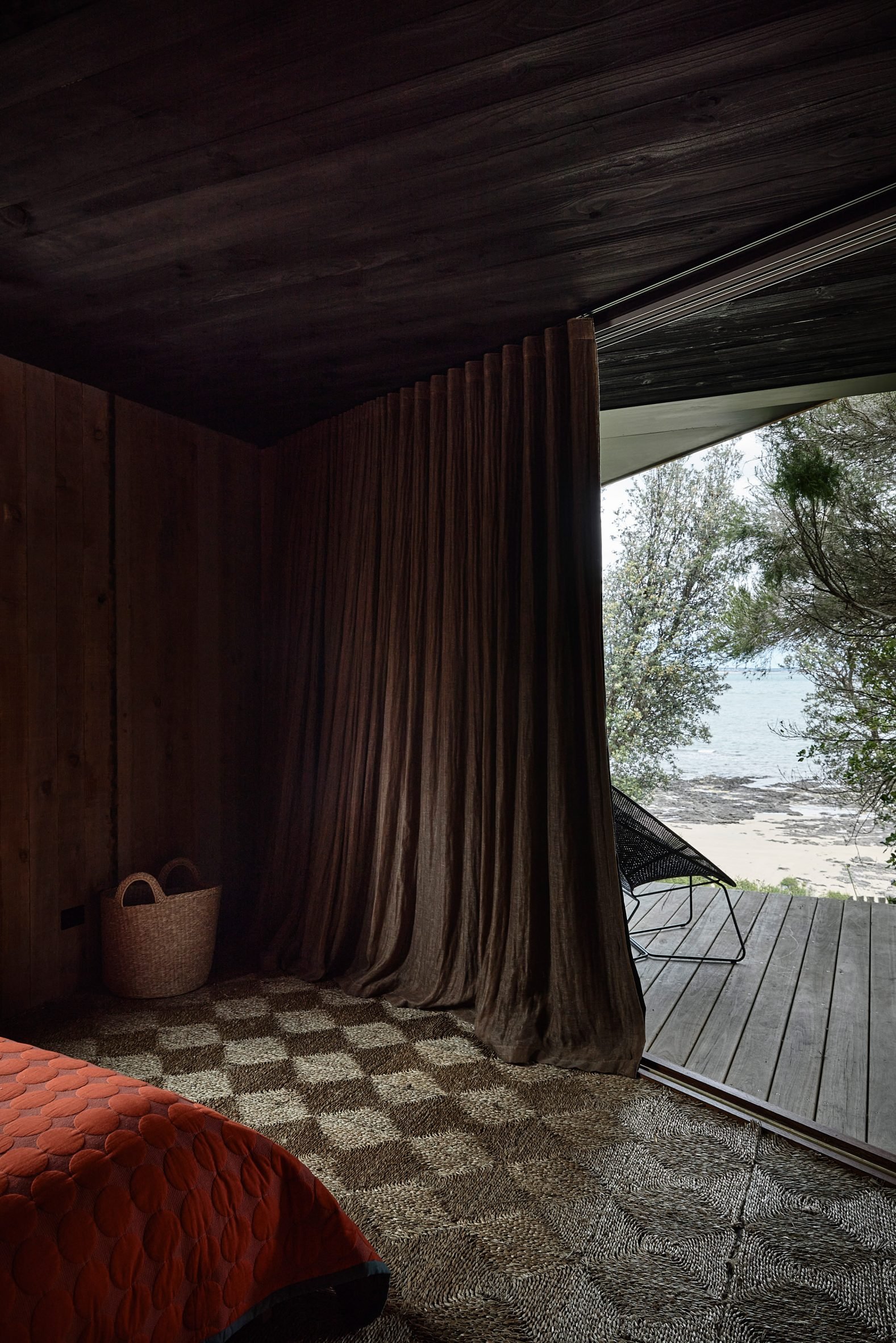 Bedroom with brown curtains covering a glass door leading outside
