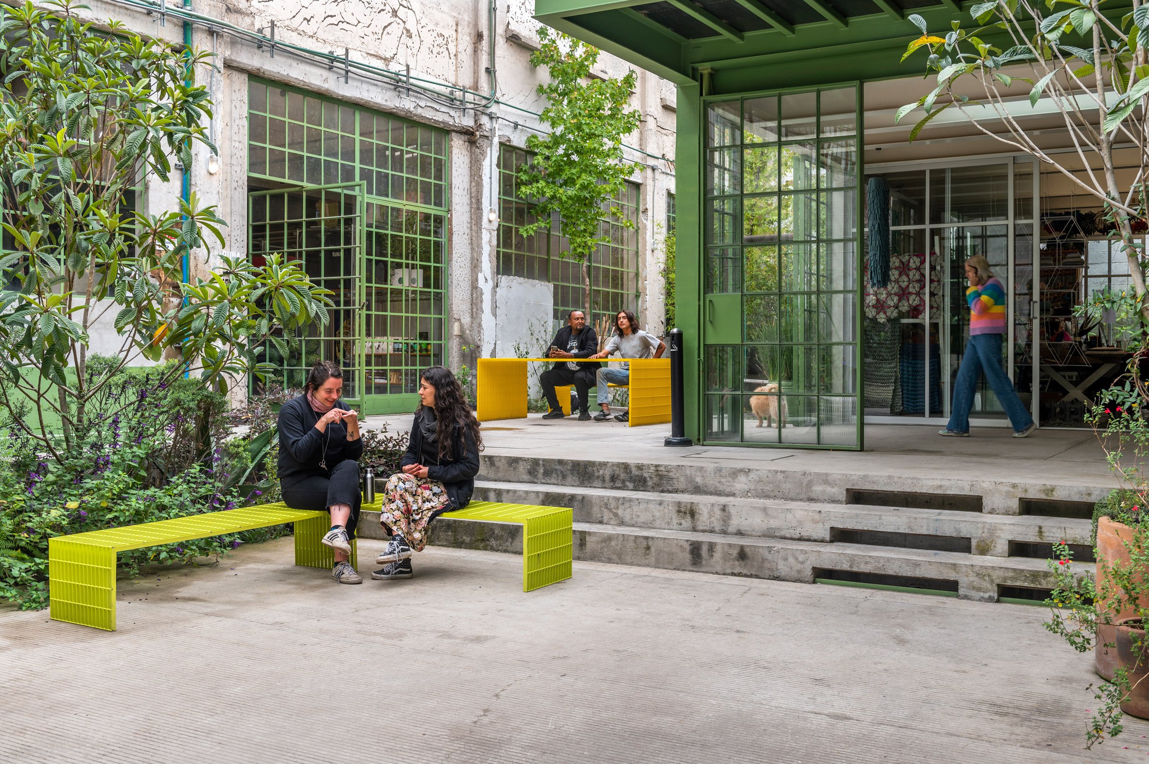 People on benches in Mexico City art space