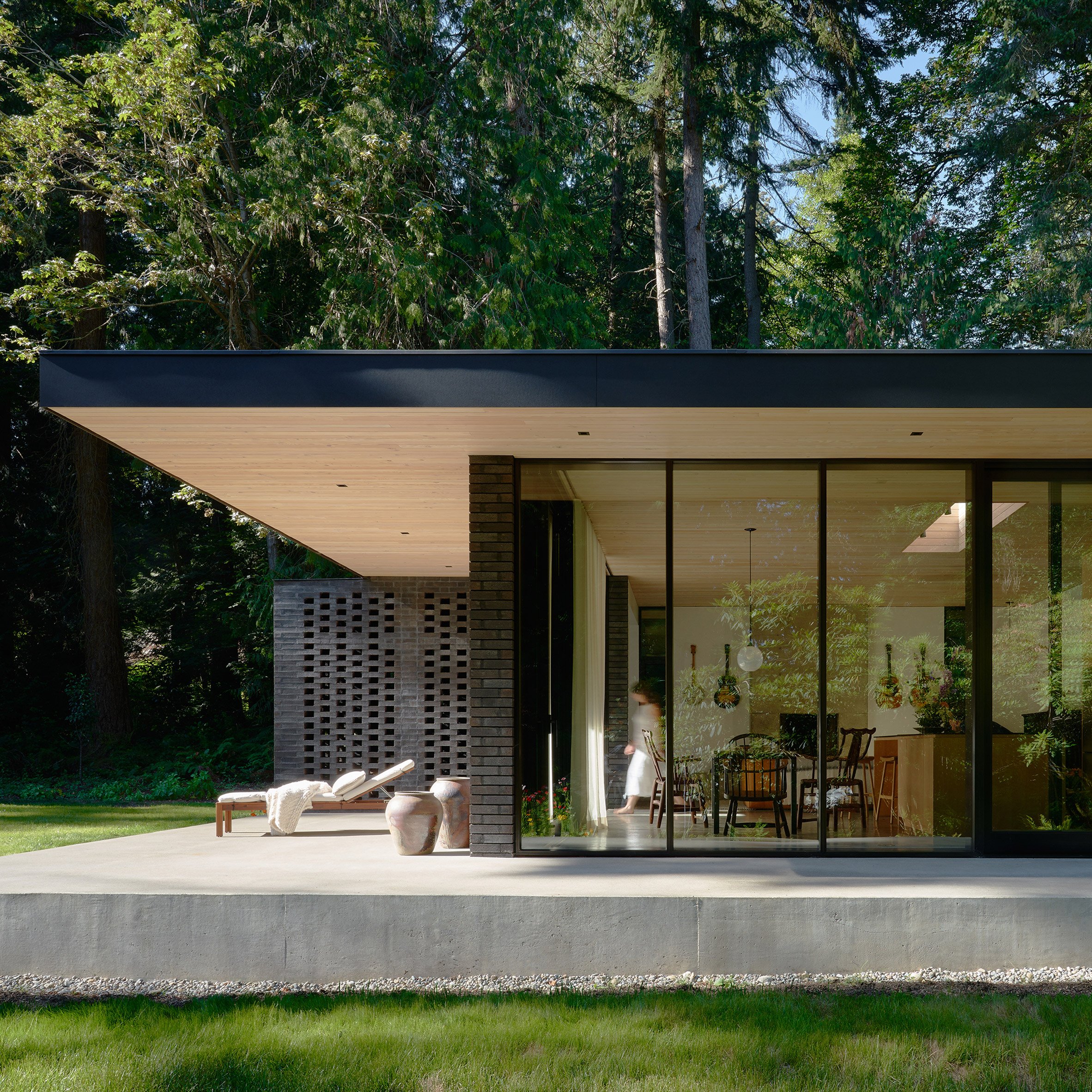 Exterior of a one-storey house on a concrete plinth by GO'C