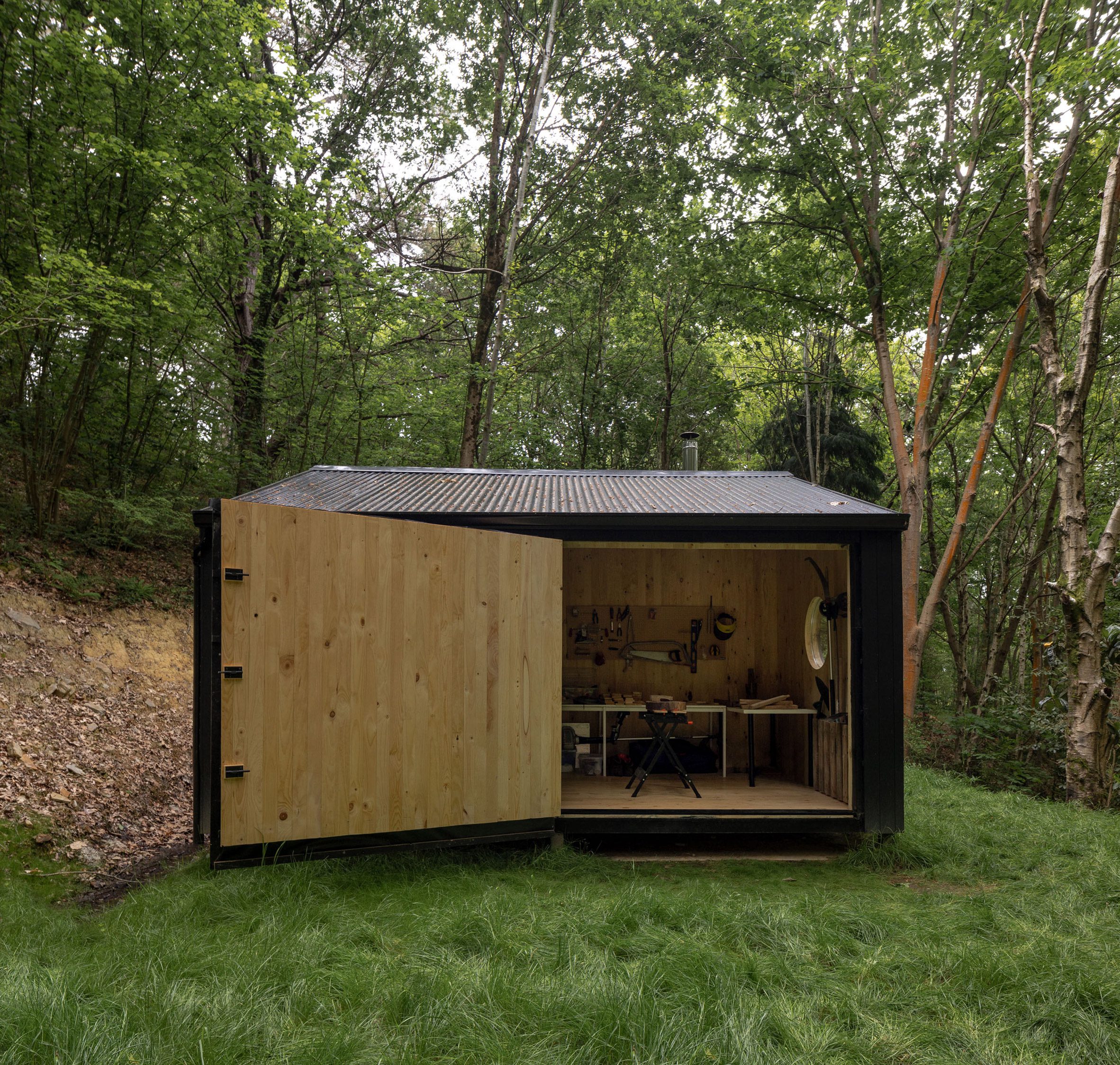 Large timber door of Aralar Cottage by BABELStudio