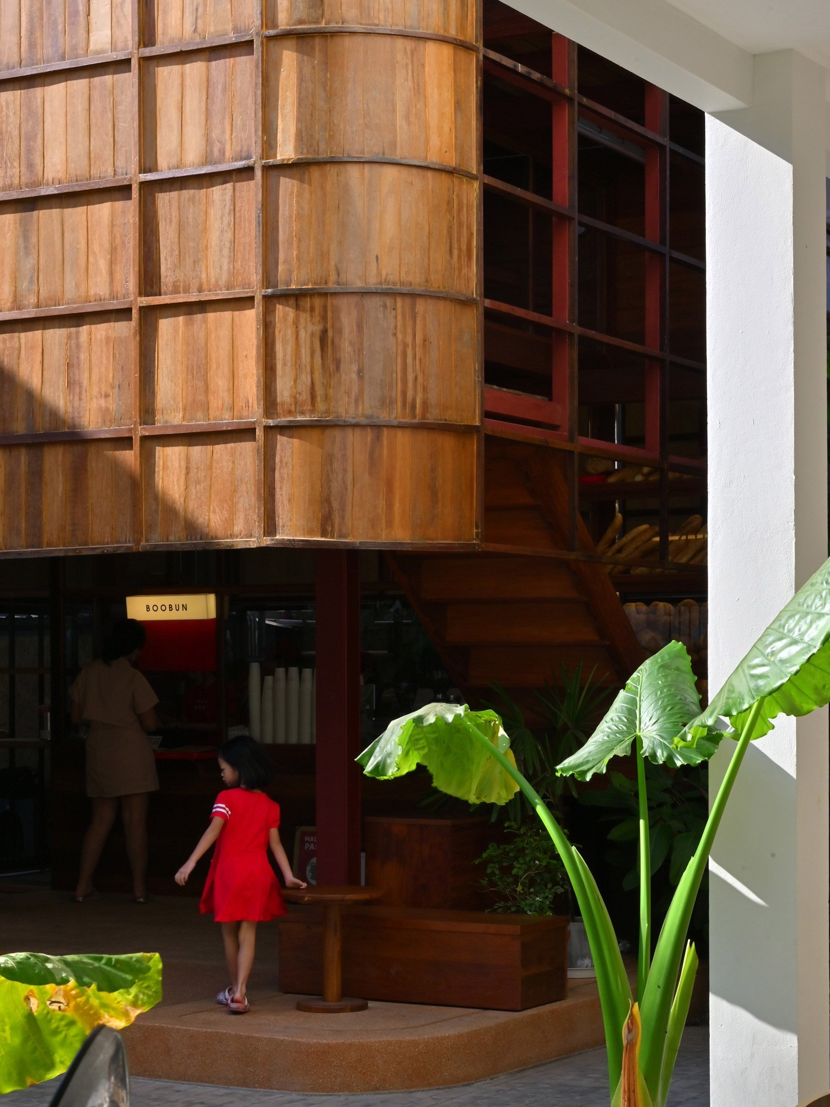 Girl inside Boobun Pocket Cafe by CUP Scale Studio