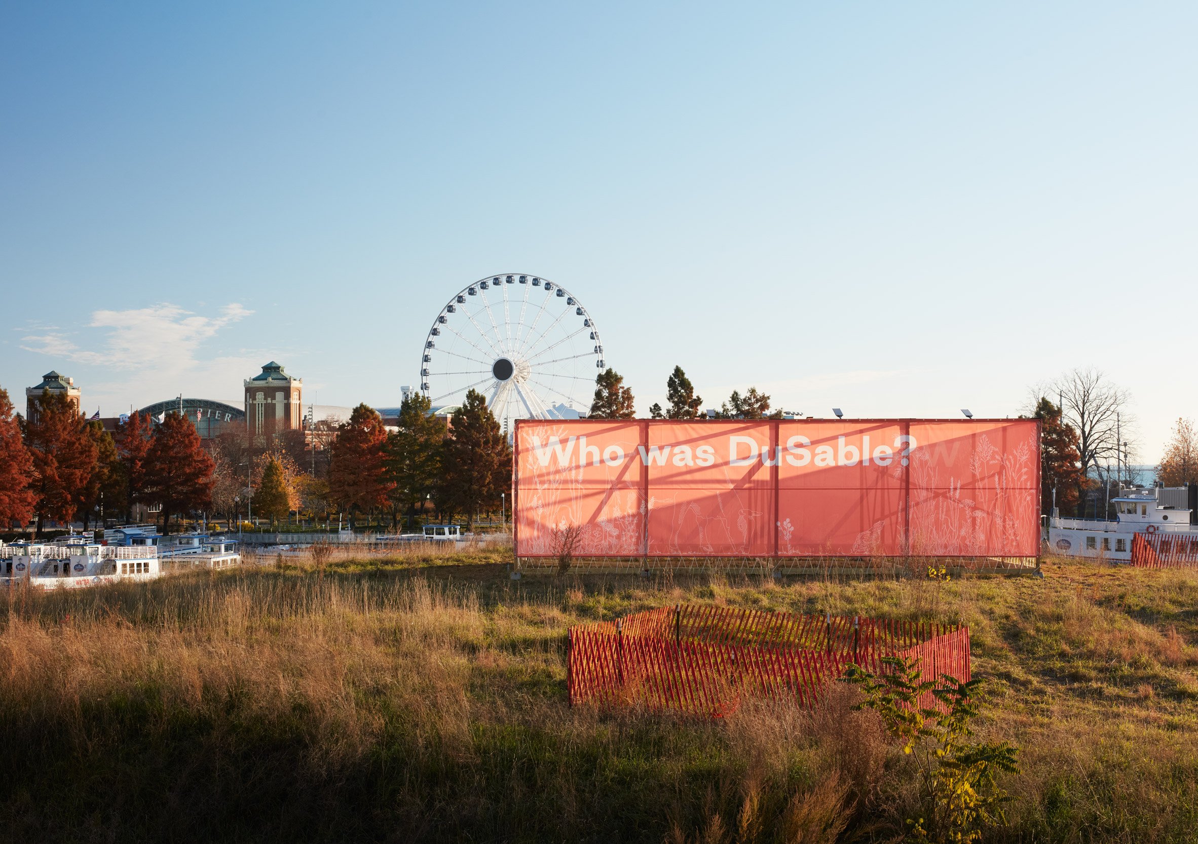Pavilion with text and ferris wheel in the background