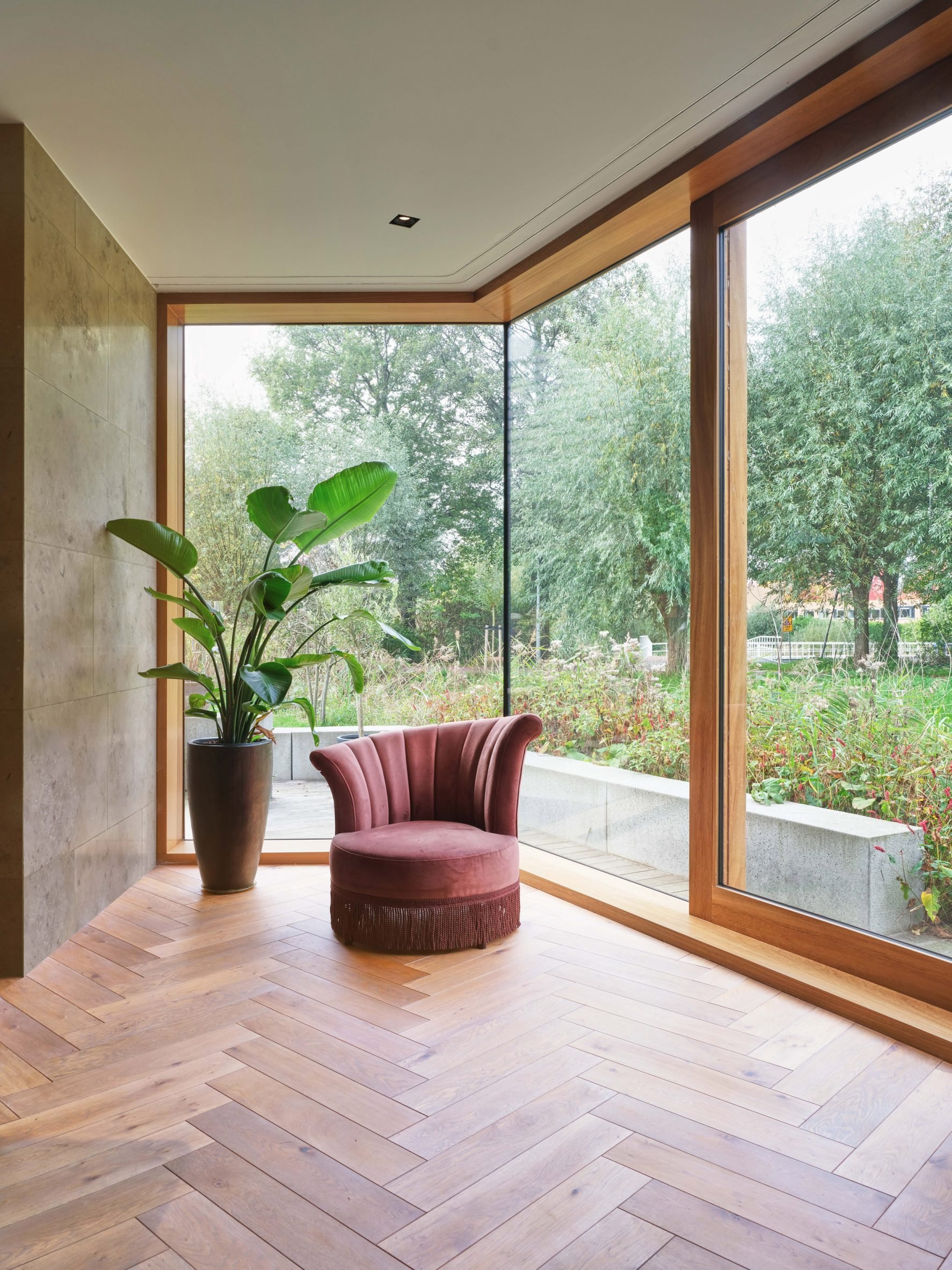 Iroko-framed window and herringbone flooring