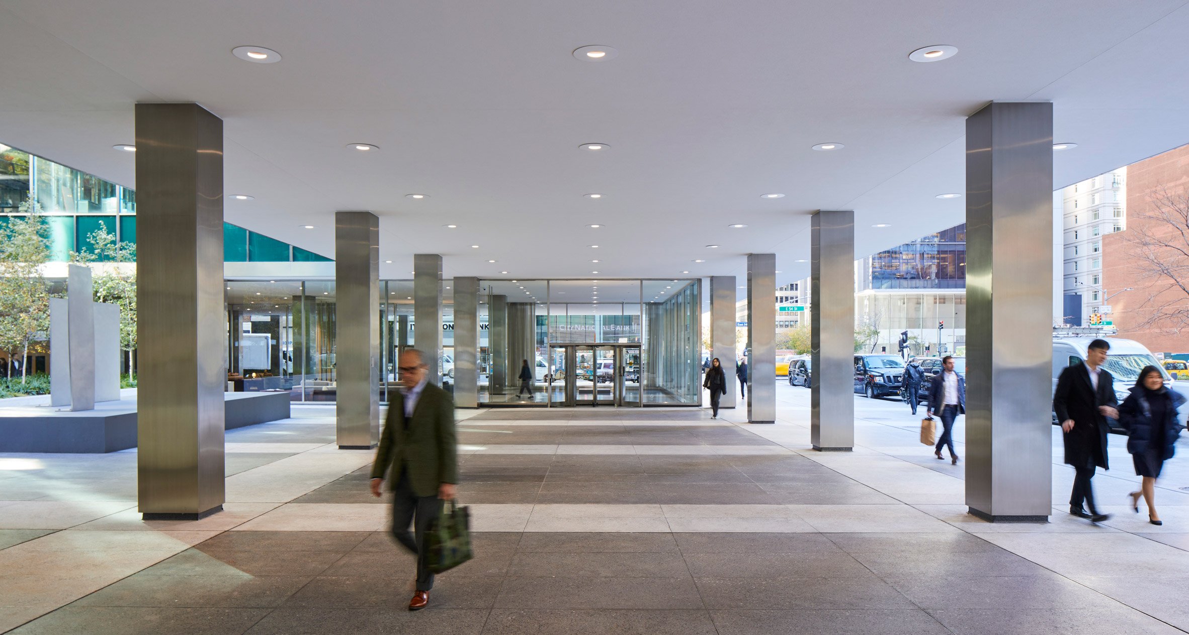 A covered plaza with gray and white terrazzo