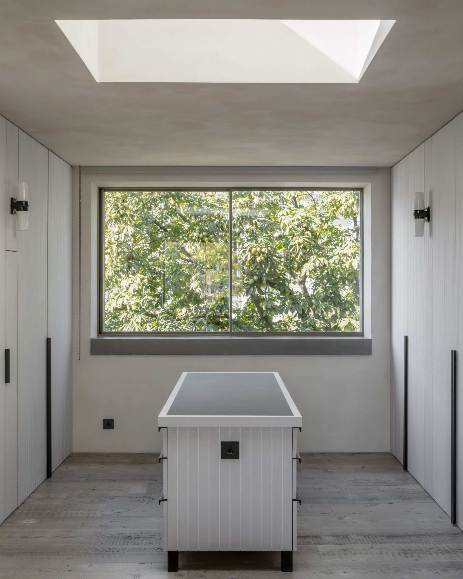 Walk-in wardrobe with skylight at the Brutalist Chelsea townhouse by Pricegore