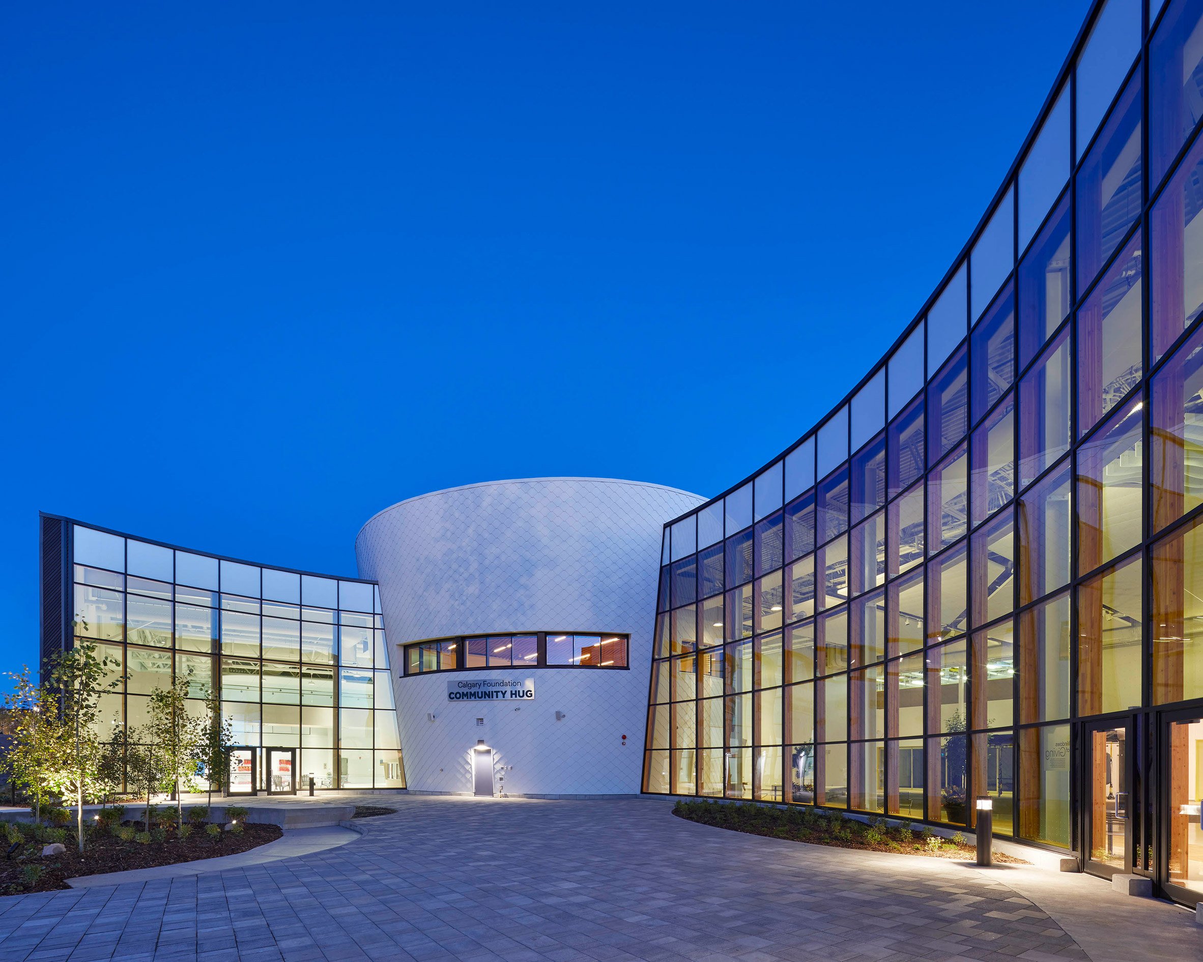 A building with a curving facade covered in glasses