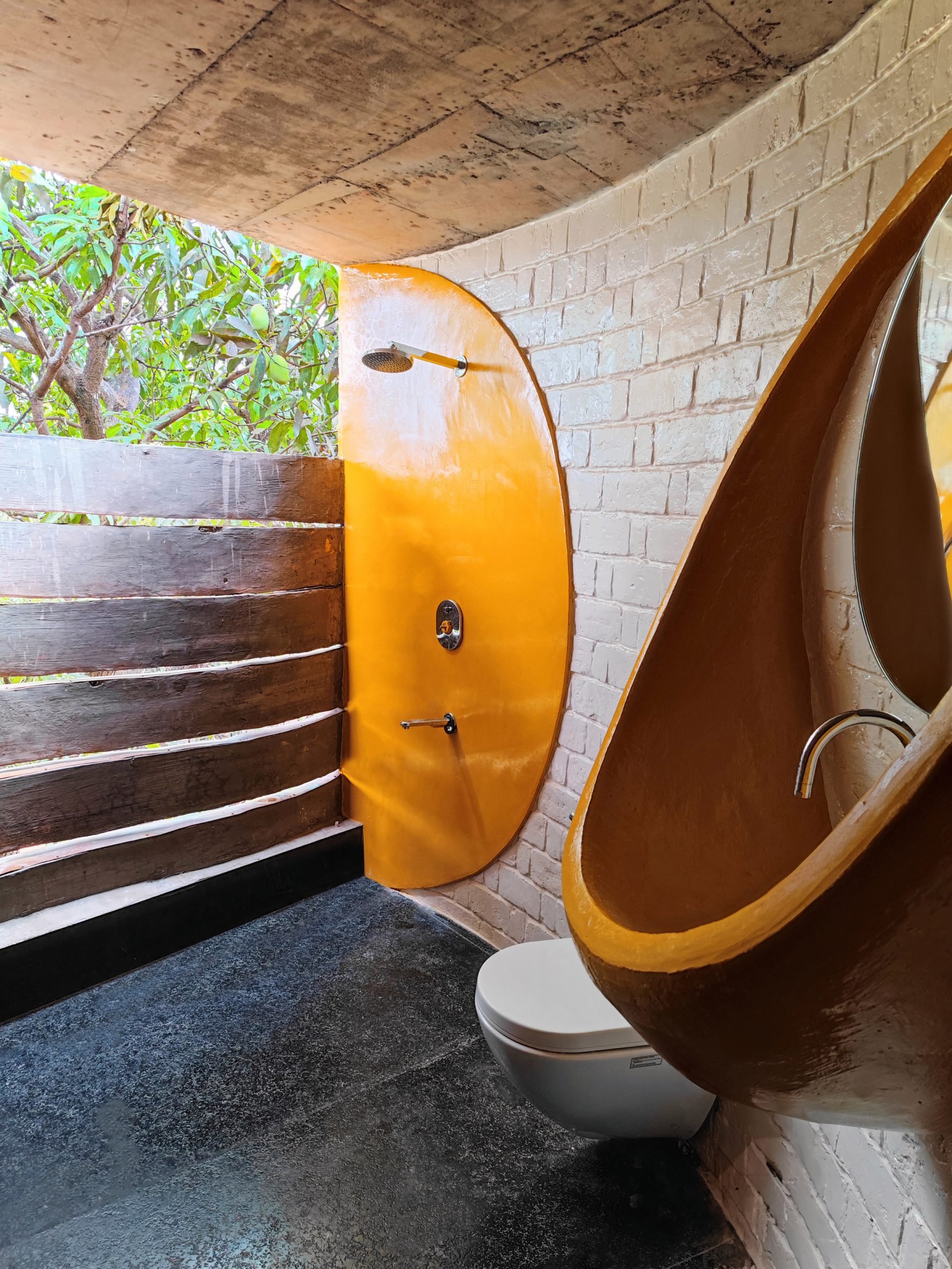 Bathroom interior with yellow fittings in Indian home