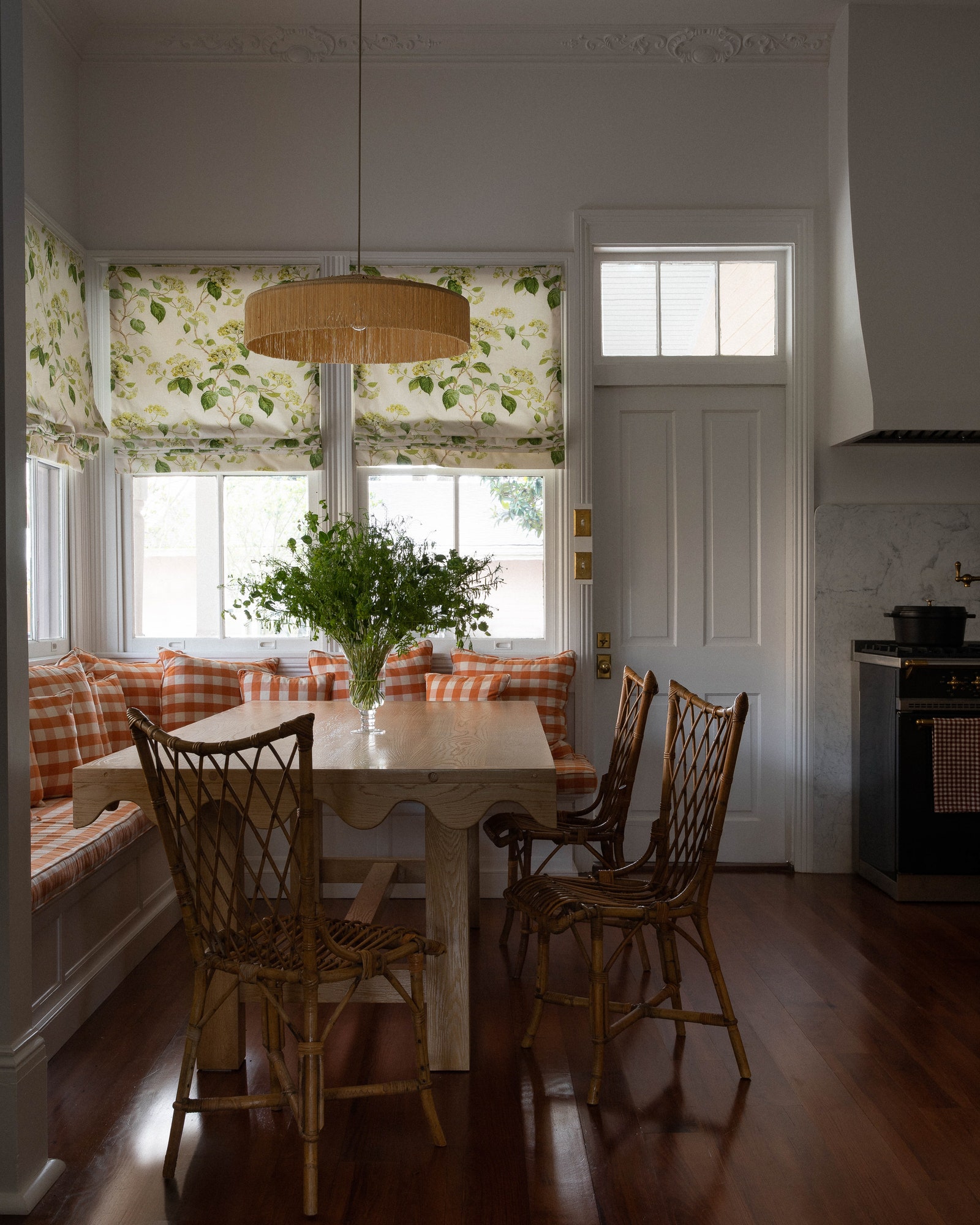 In a New Orleans home designed by Lafayette Studio French rattan chairs dating from the 1950s surround a custom table...
