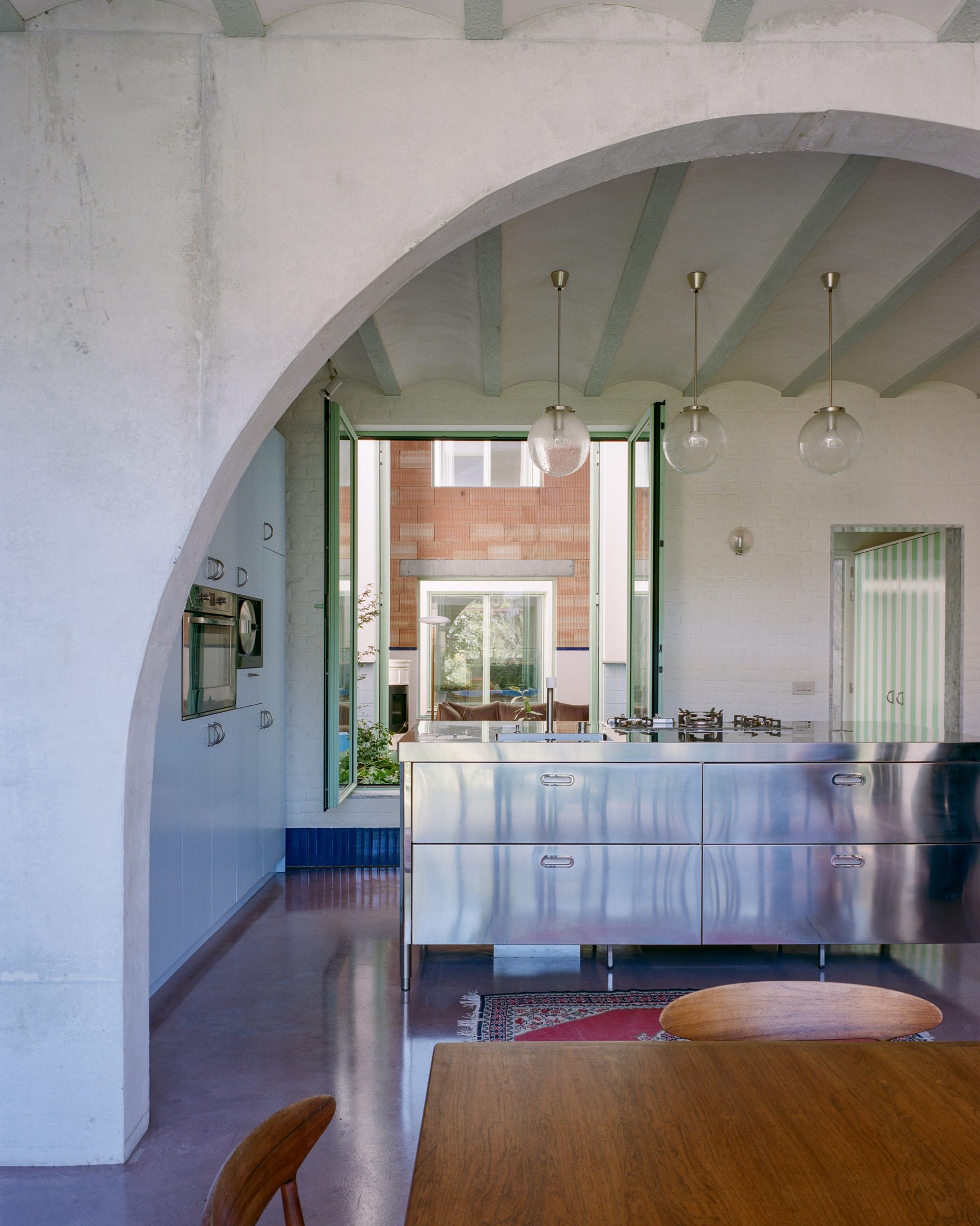 Kitchen top and arch in Dailly warehouse home by Mamout in Belgium