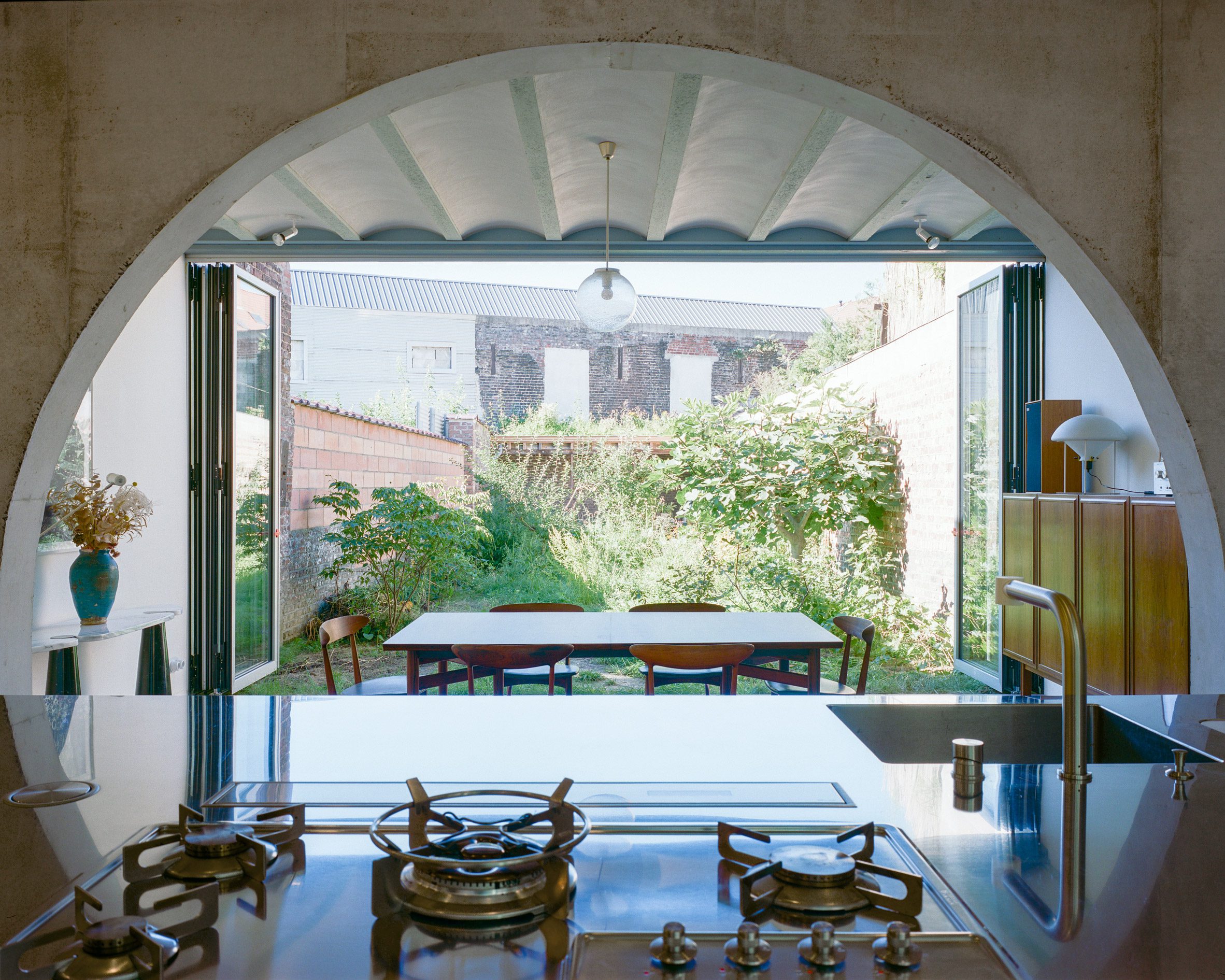 Kitchen to garden view of Dailly warehouse home by Mamout in Belgium