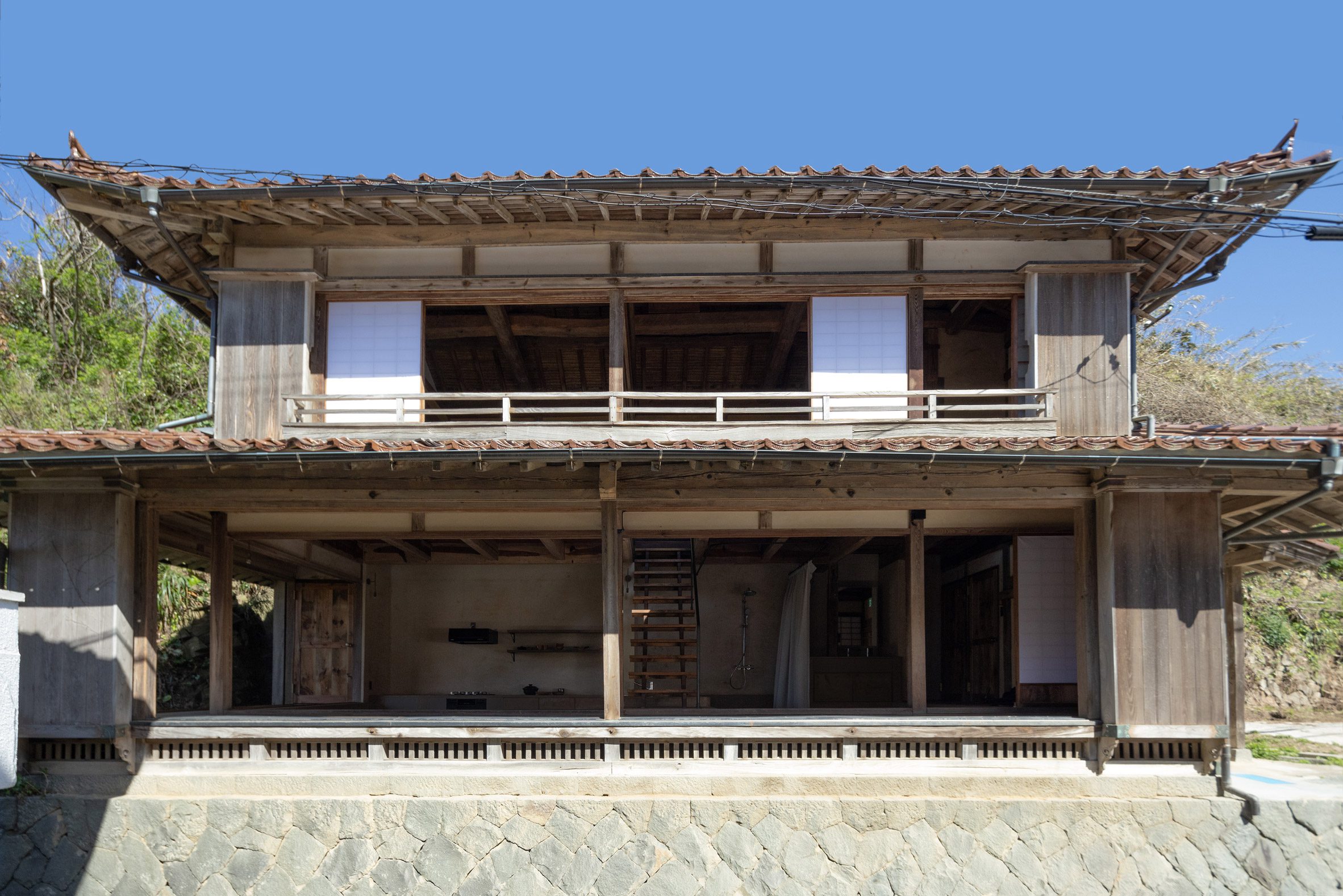 Exterior view of renovated minimalist home in Misumi, Japan by Studio AMB