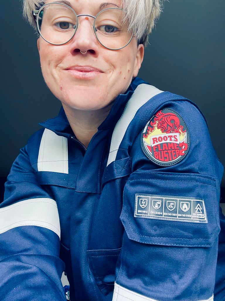 Photo of a woman wearing a blue uniform.