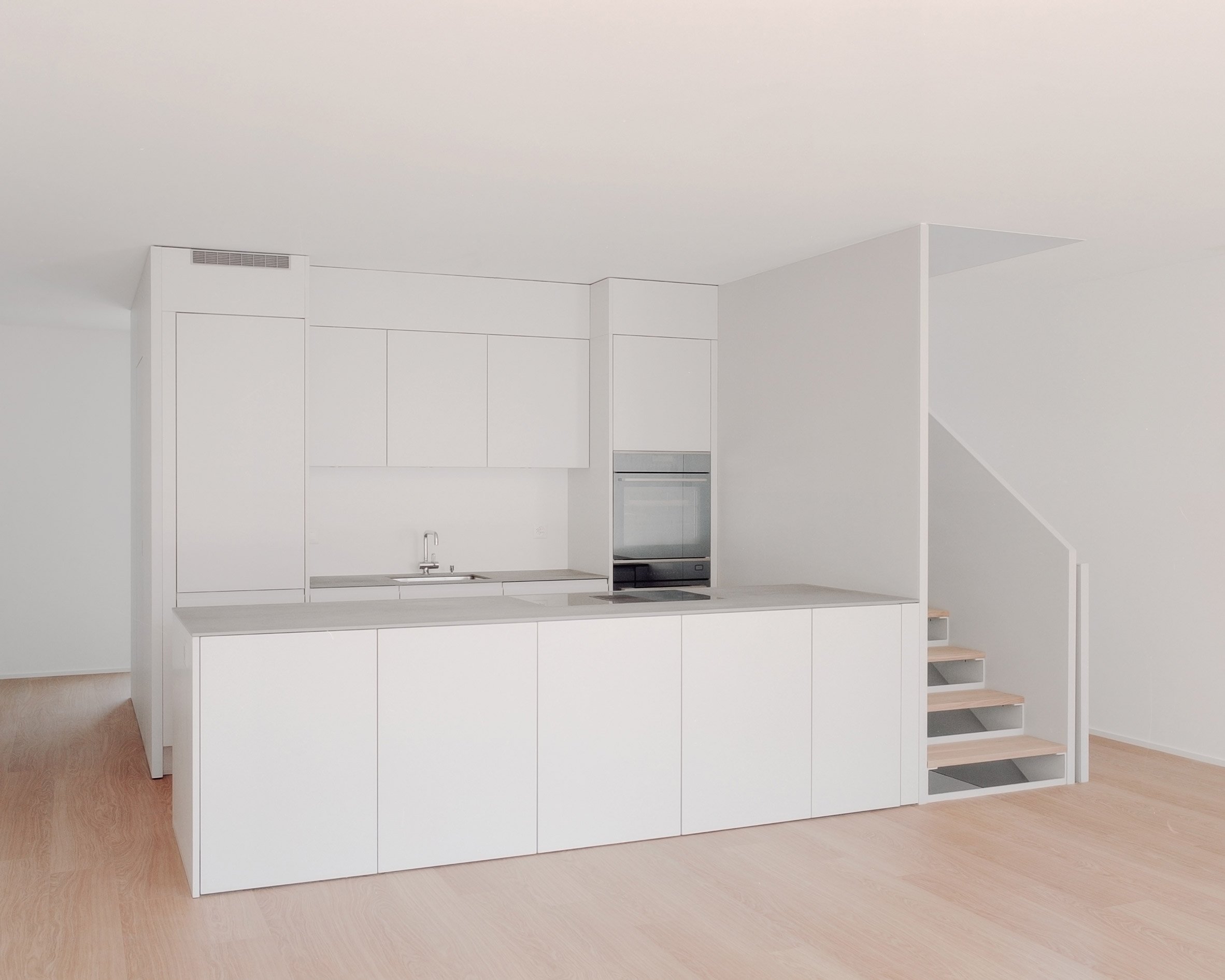 Kitchen interior of the concrete terrace houses in Switzerland by Atelier Rampazzi