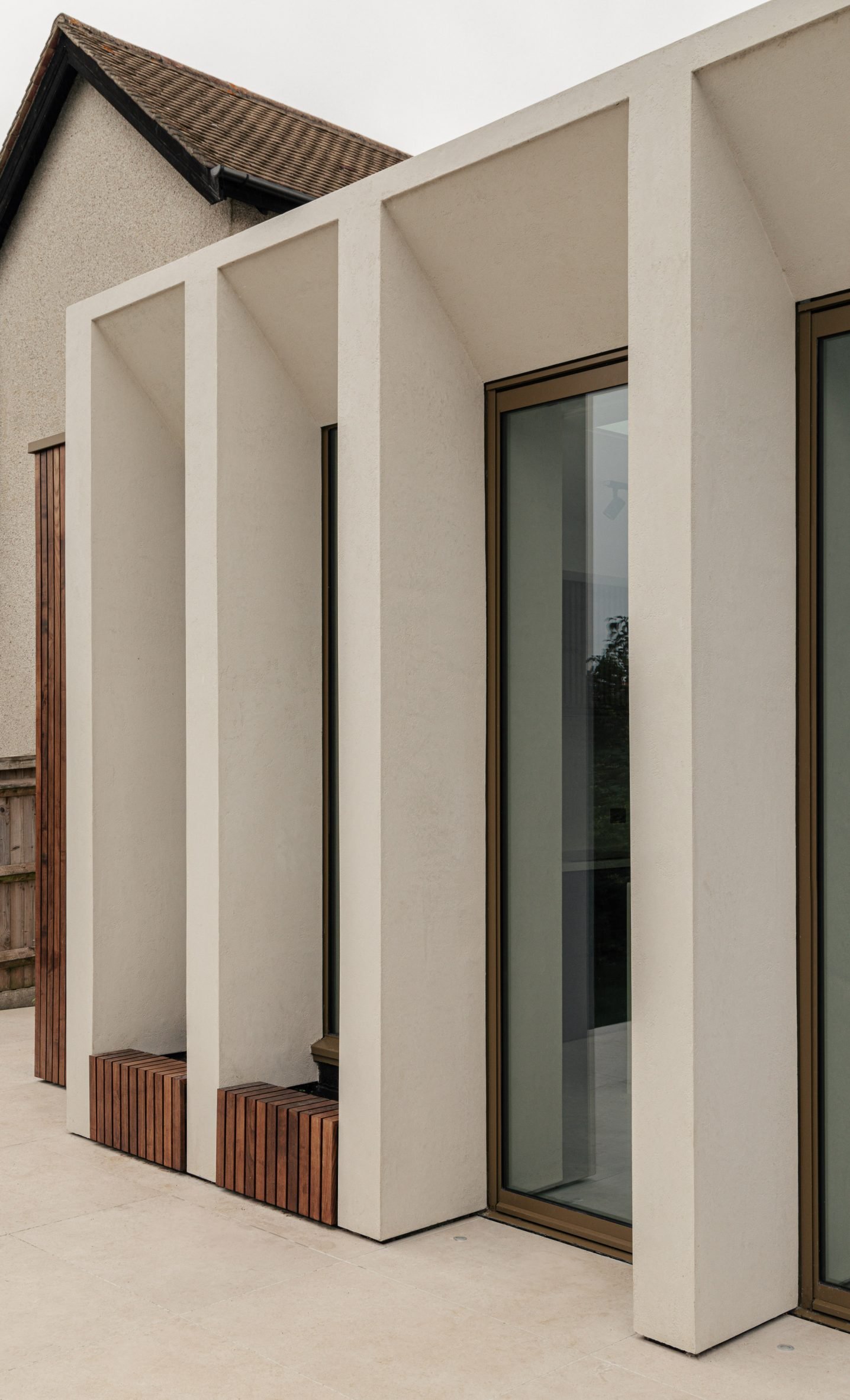 Angled microcement colonnade by Will Gamble Architects in Croydon, London