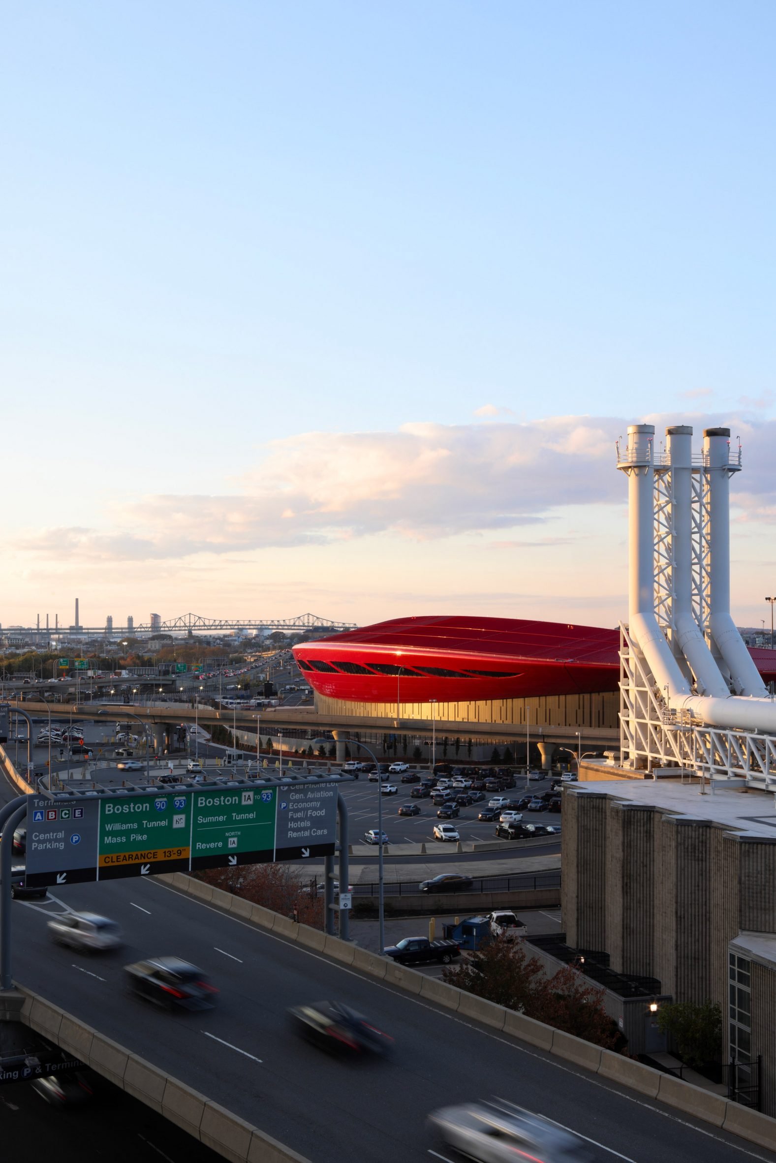 Red boston airport with smokestacks in foreground