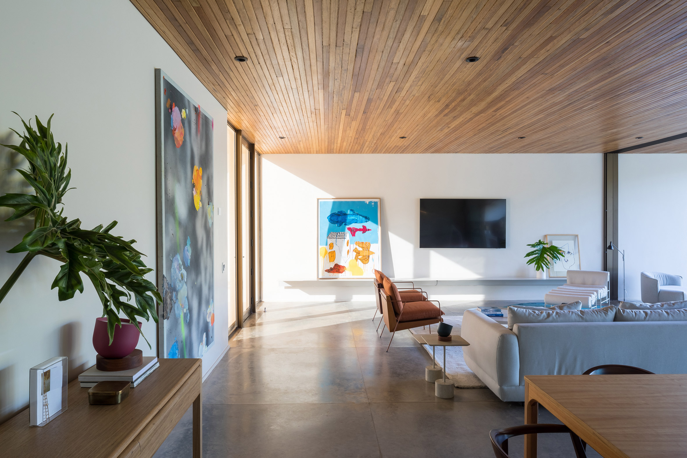 A living room with colorful paintings