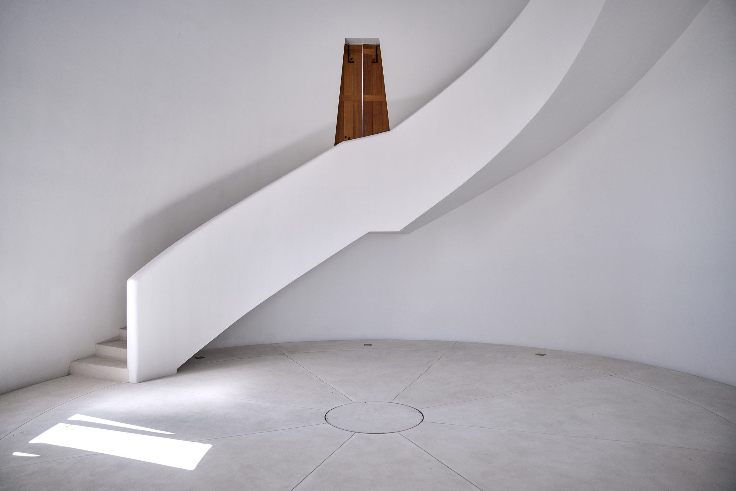 Entrance space of El Faro lighthouse with spiral staircase leading up