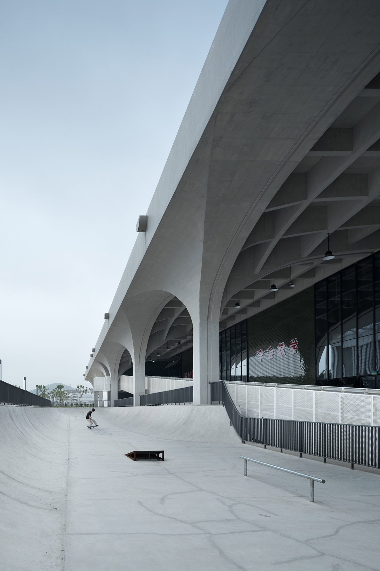 Skater outside vaulted concrete structure in China