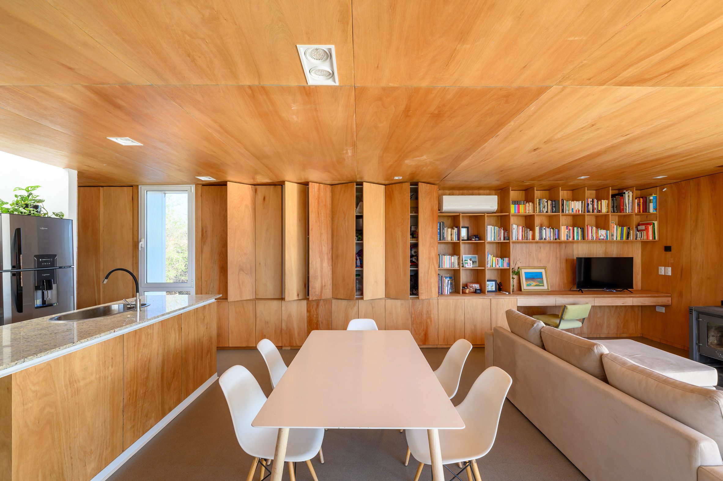 A living room clad in wood cabinetry