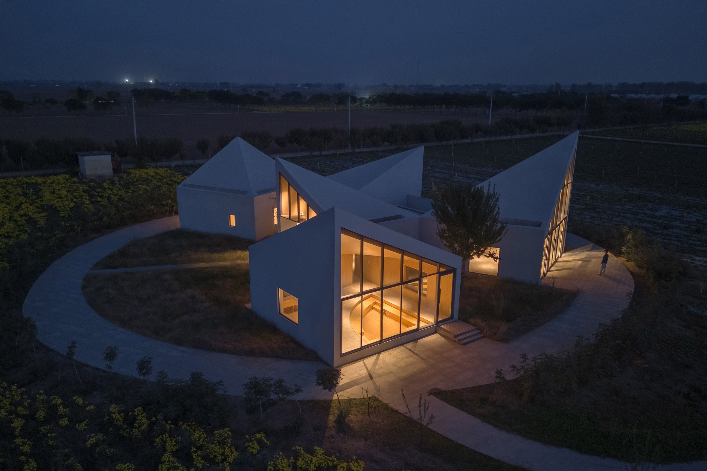 View of library illuminated at night by Atelier Xi