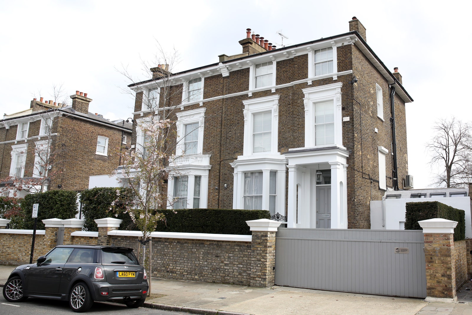 Image may contain Architecture Building Housing Car Transportation Vehicle House Row House Person and Chair