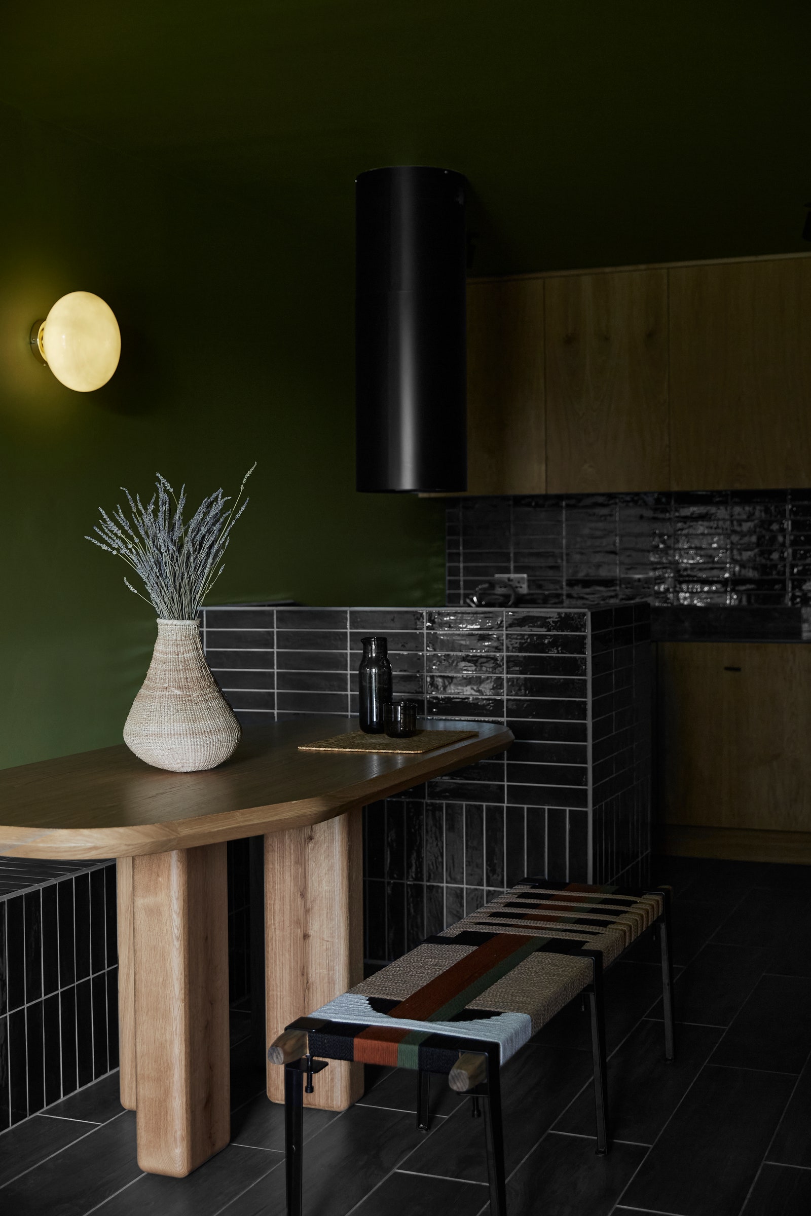 Image may contain Indoors Interior Design Dining Table Furniture Table Bench Lamp Floor Lighting and Wood