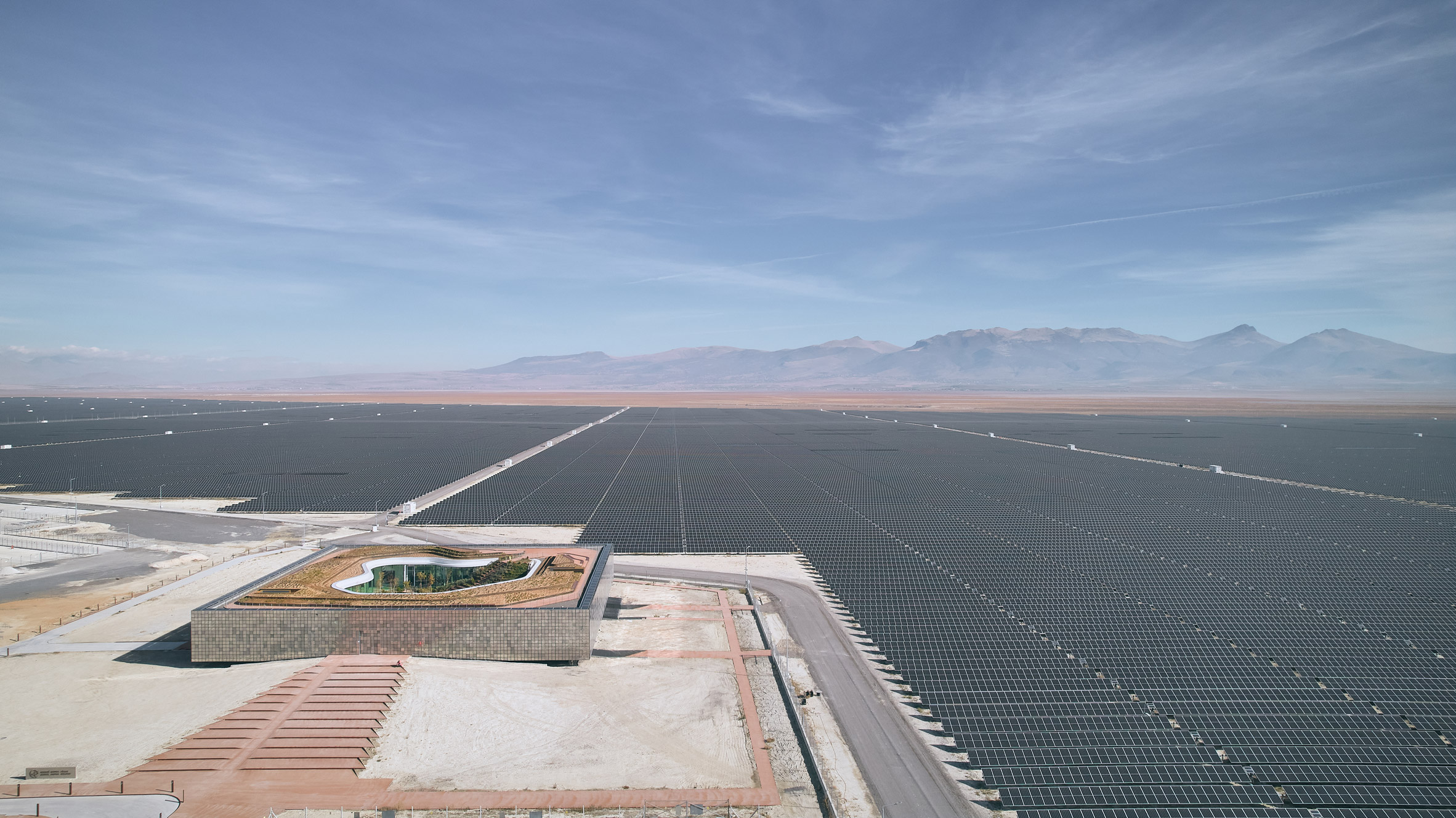 Aerial view of Central Control Building by Bilgin Architects amongst solar farm