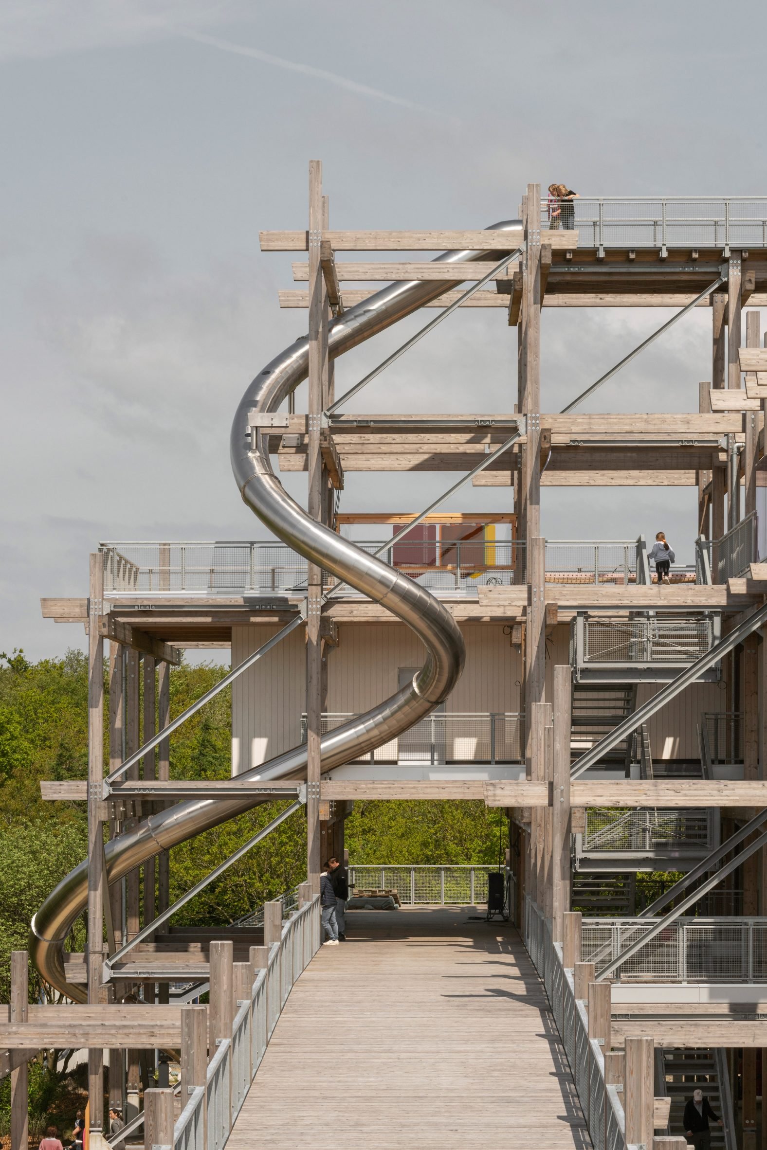 Silver slide spiralling around a timber frame structure