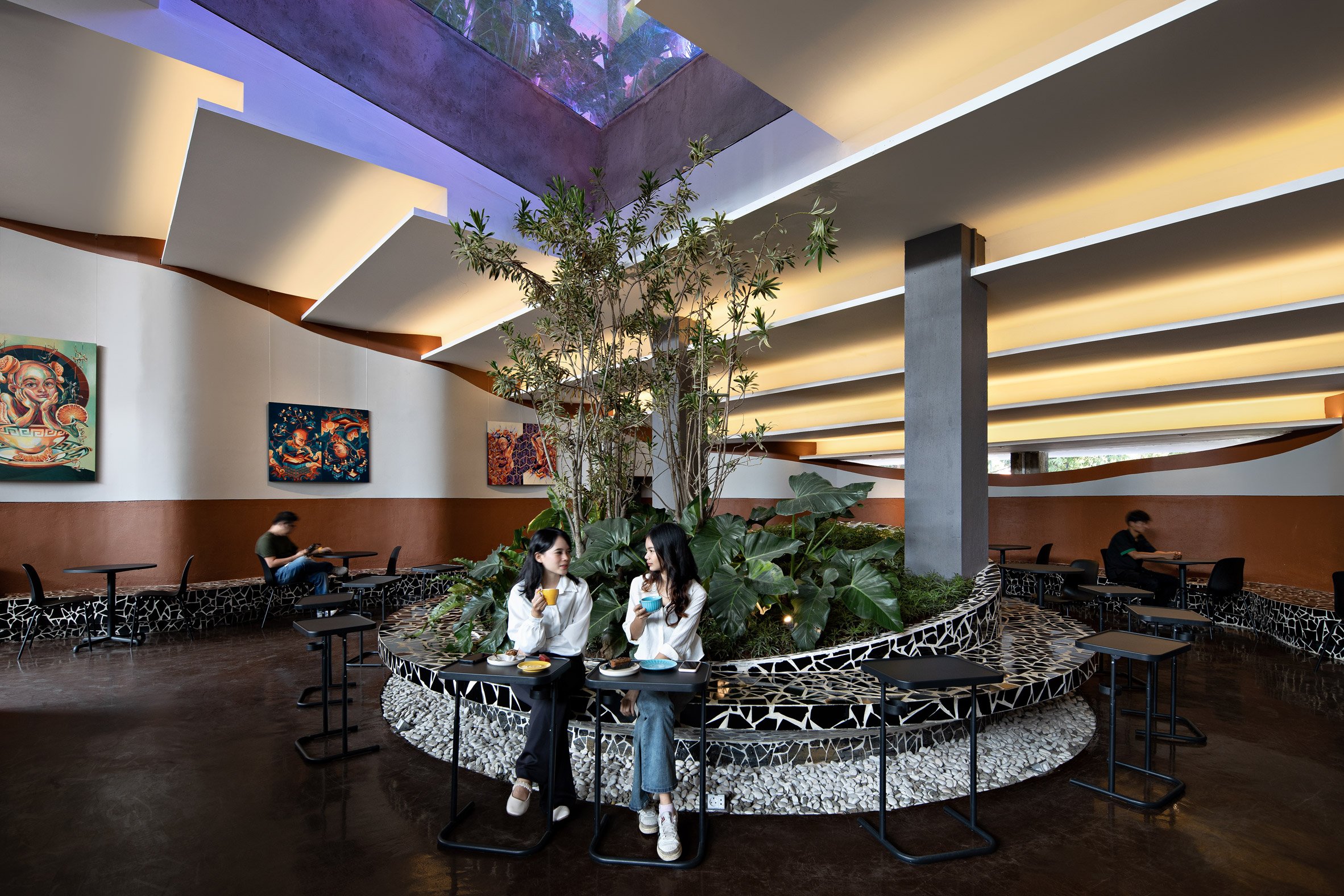 Seating area illuminated by skylights at Frame Garden in Jakarta