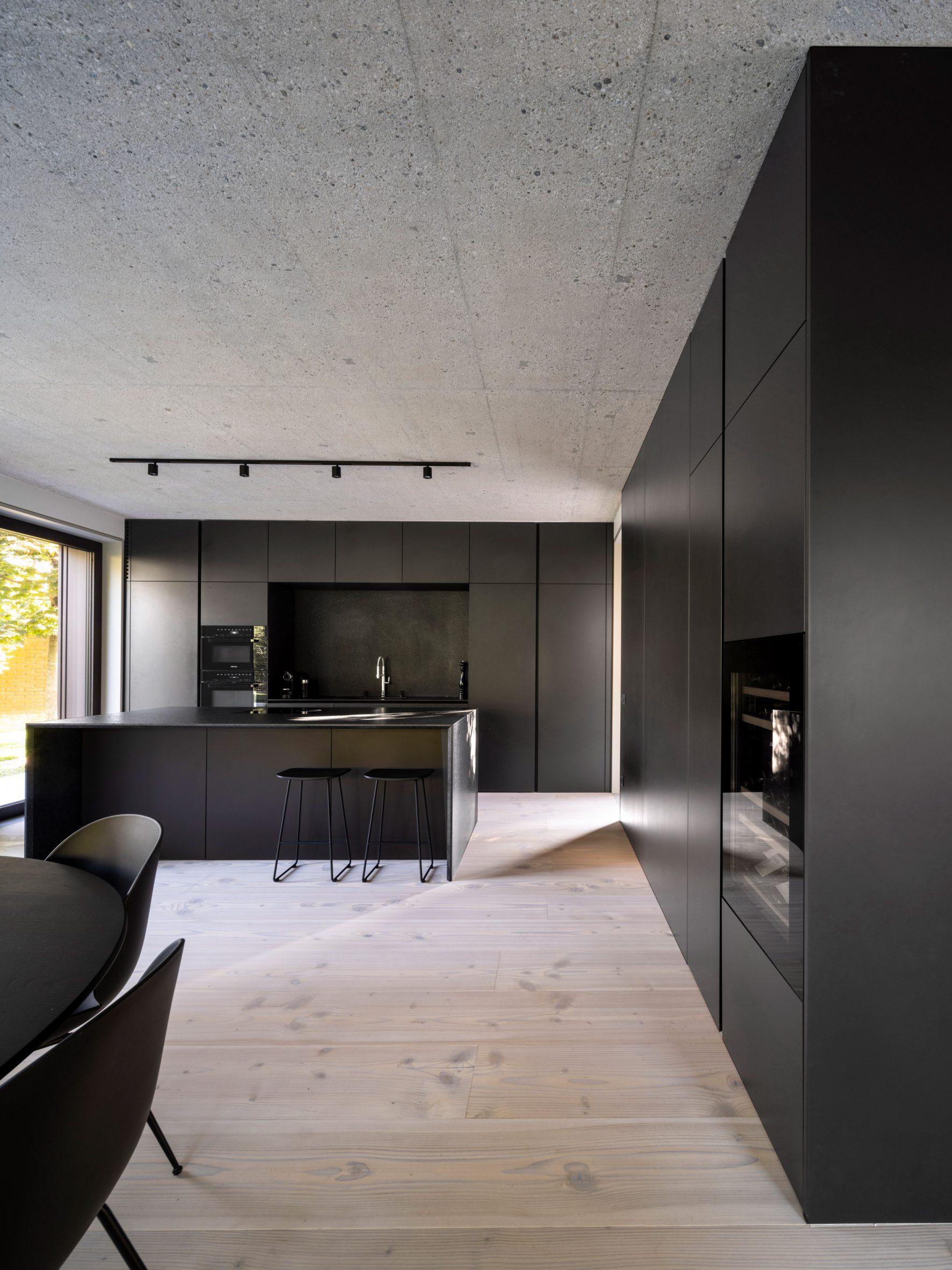 Kitchen and dining interior within family home by OFIS Arhitekti
