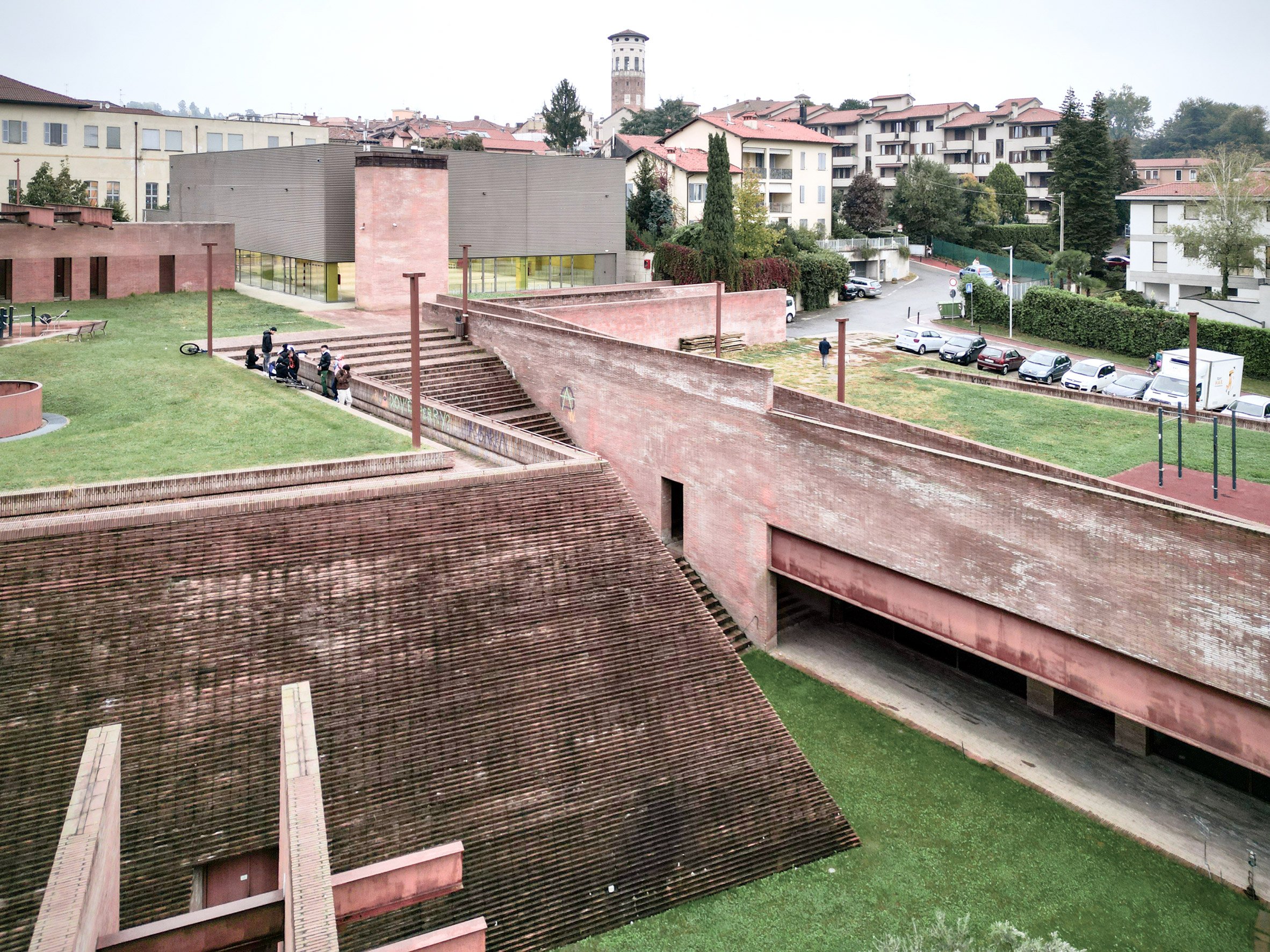 Concrete-clad gym in a brick piazza