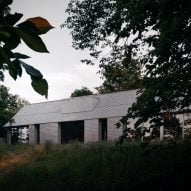 Grey cedar home with trees in foregroud