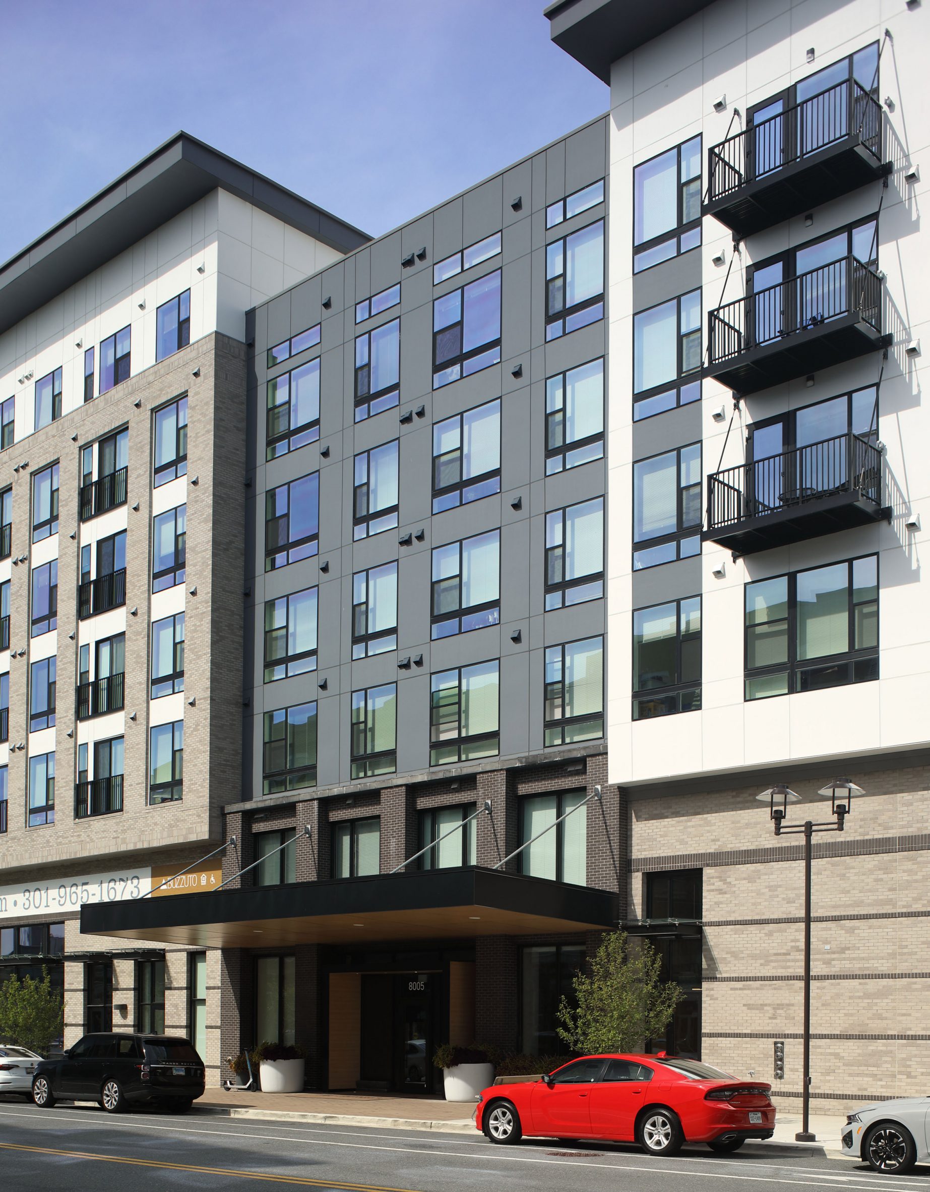 Facade of Maryland apartment complex with red car in front