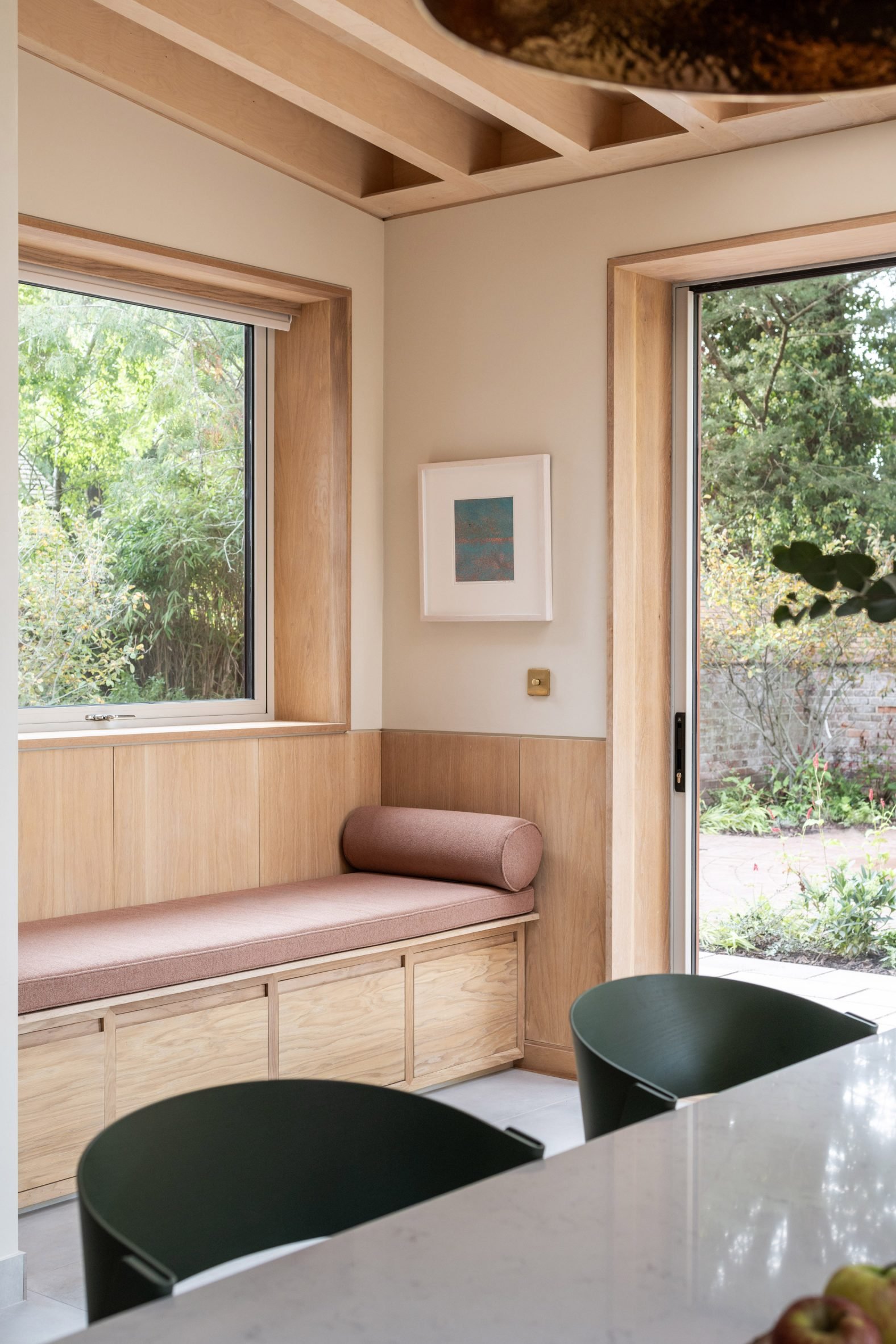 Wood-lined living space with window seat