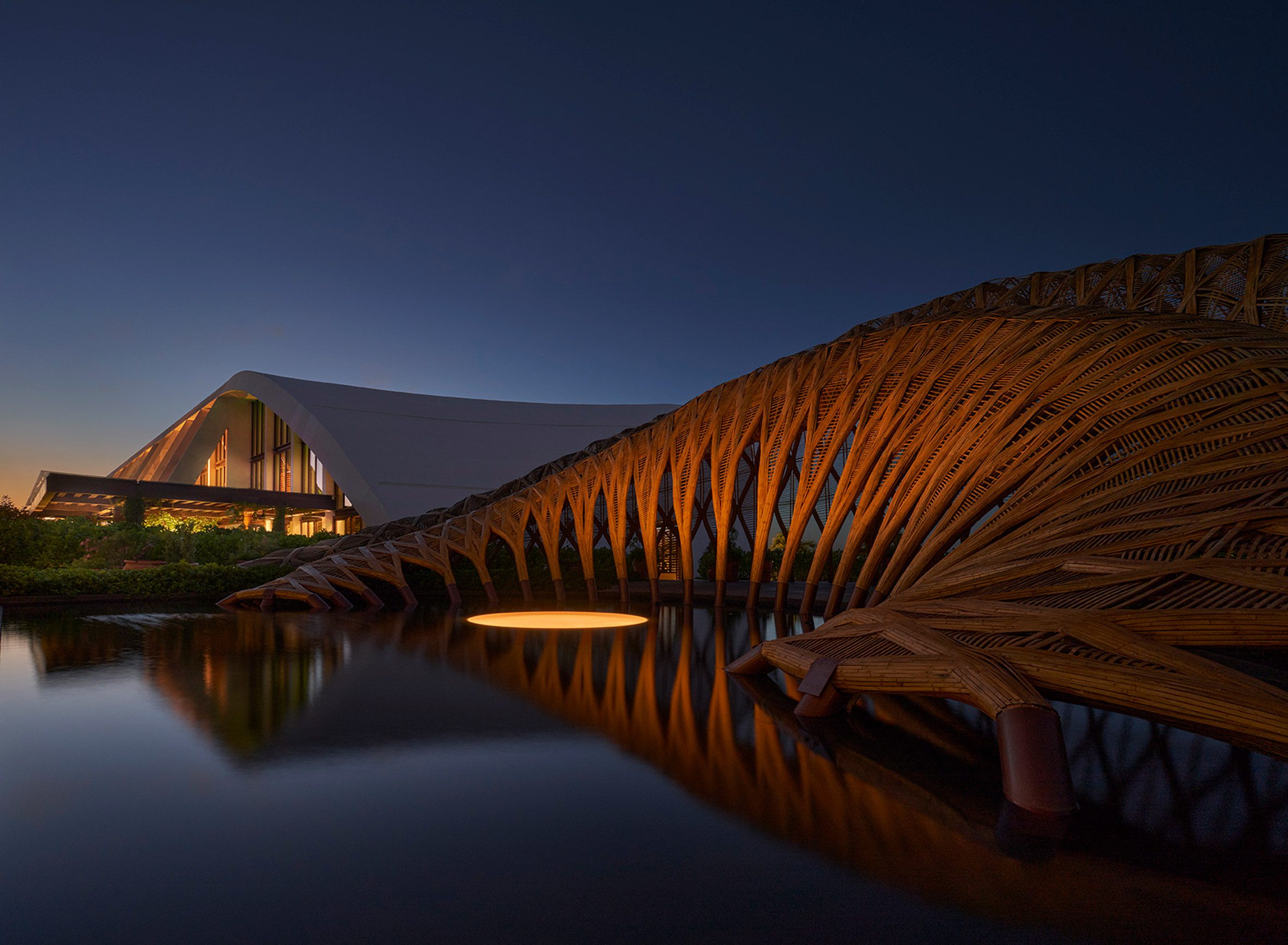 Sloping buildings and bamboo pavilion around a pool