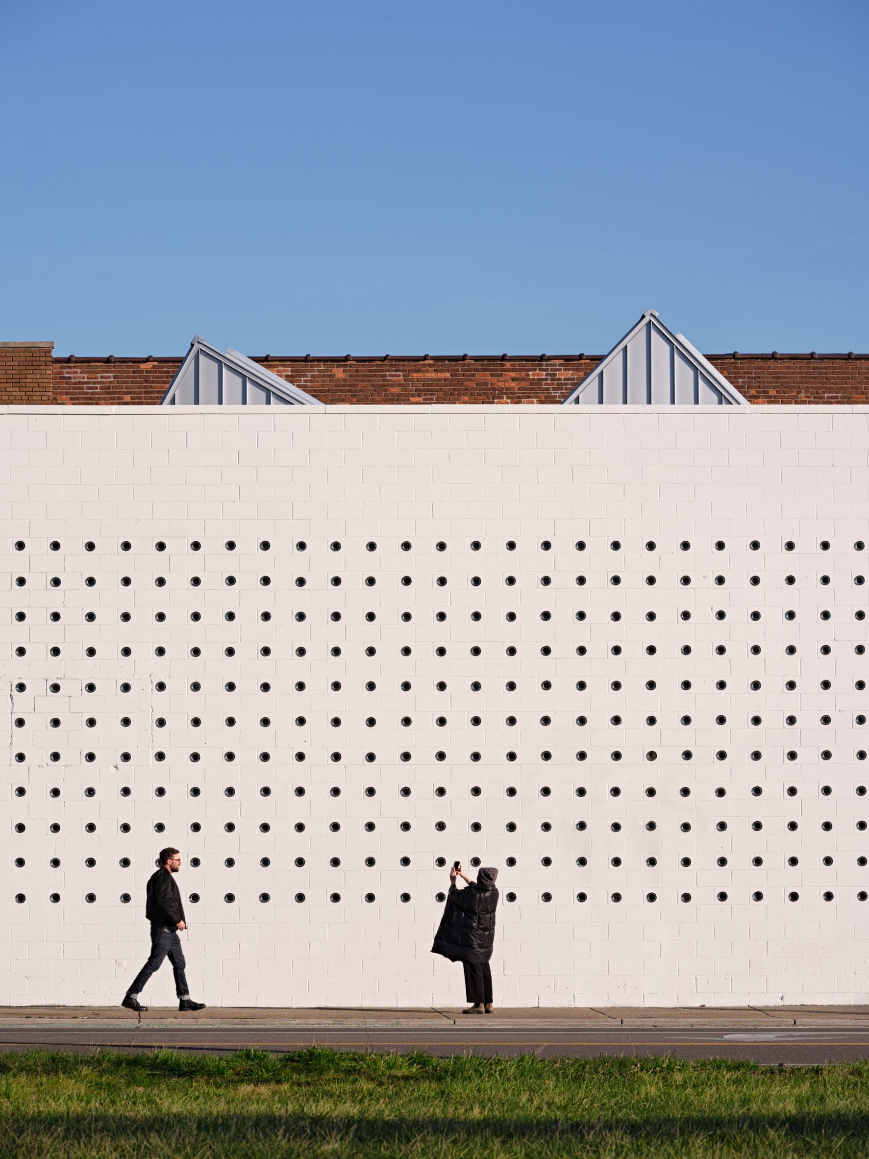 CMU wall punched with small circular windows at Lantern arts centre