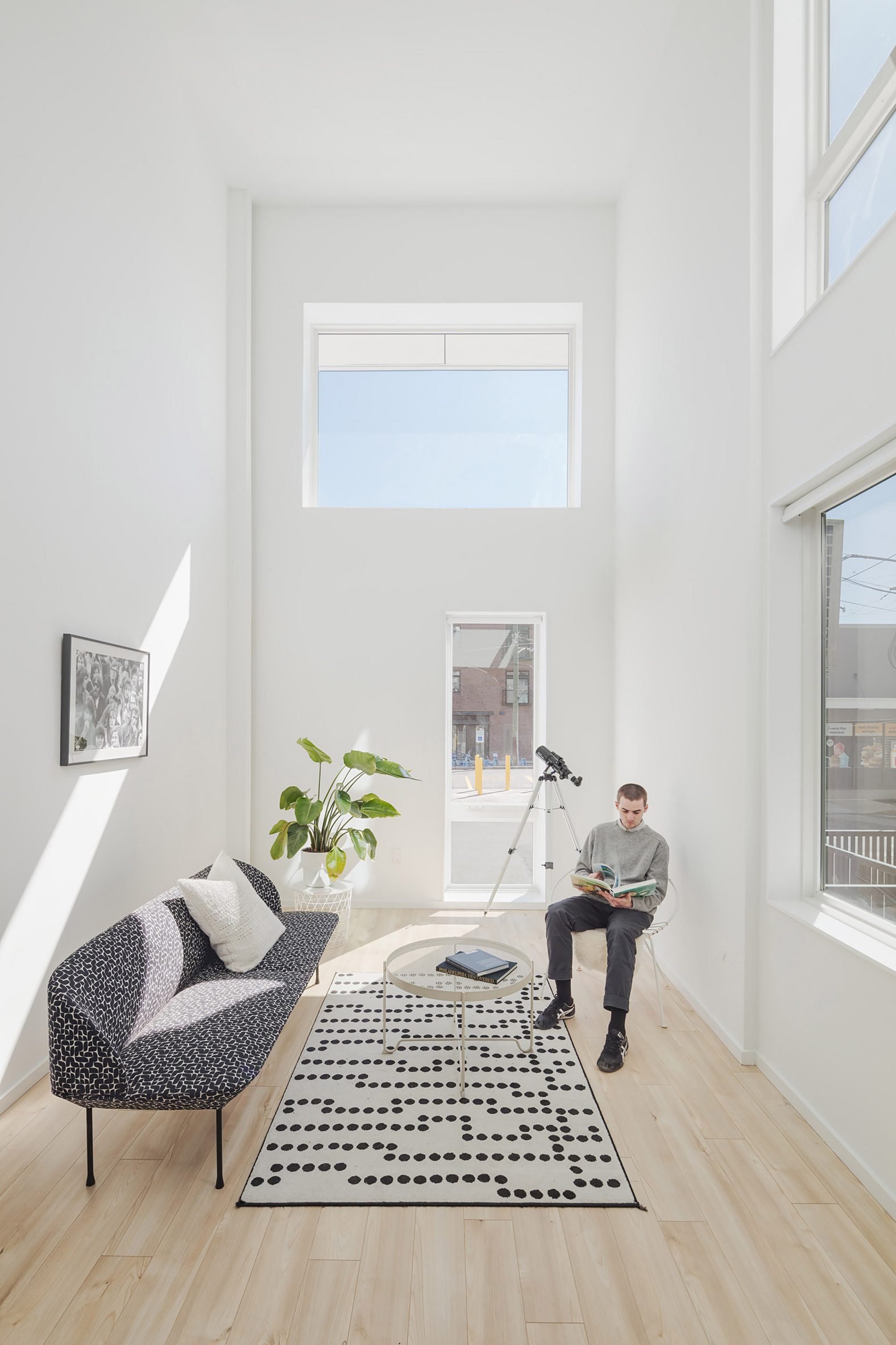 Person sitting in white room