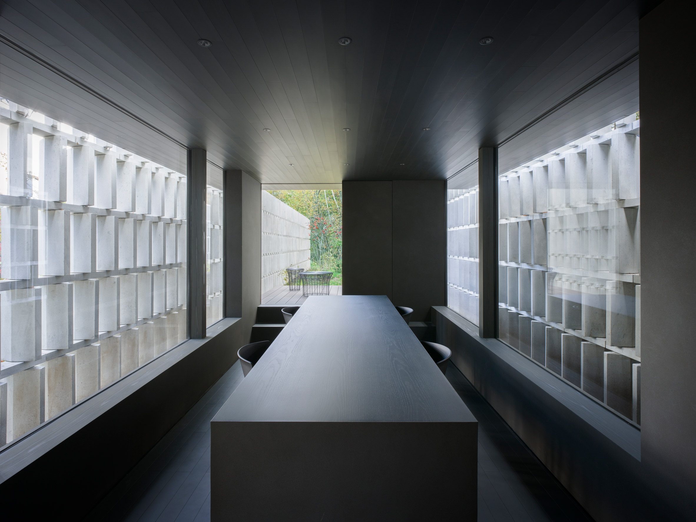 Dining space within Block Wall House