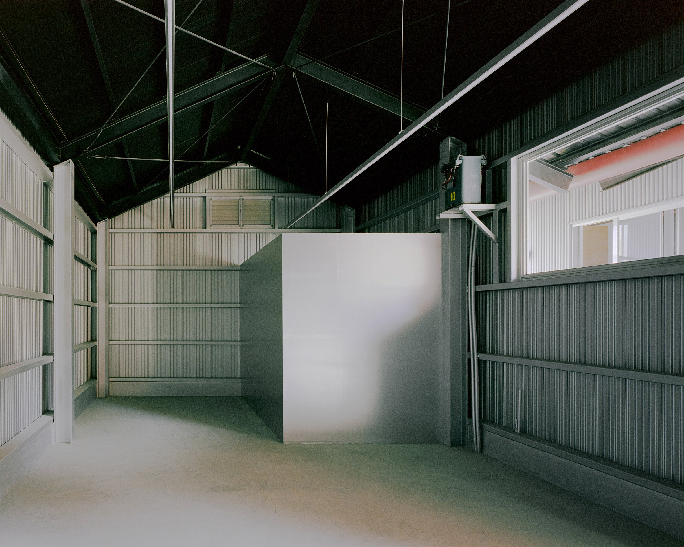Storage space within metal home by Studio Tngtetshiu