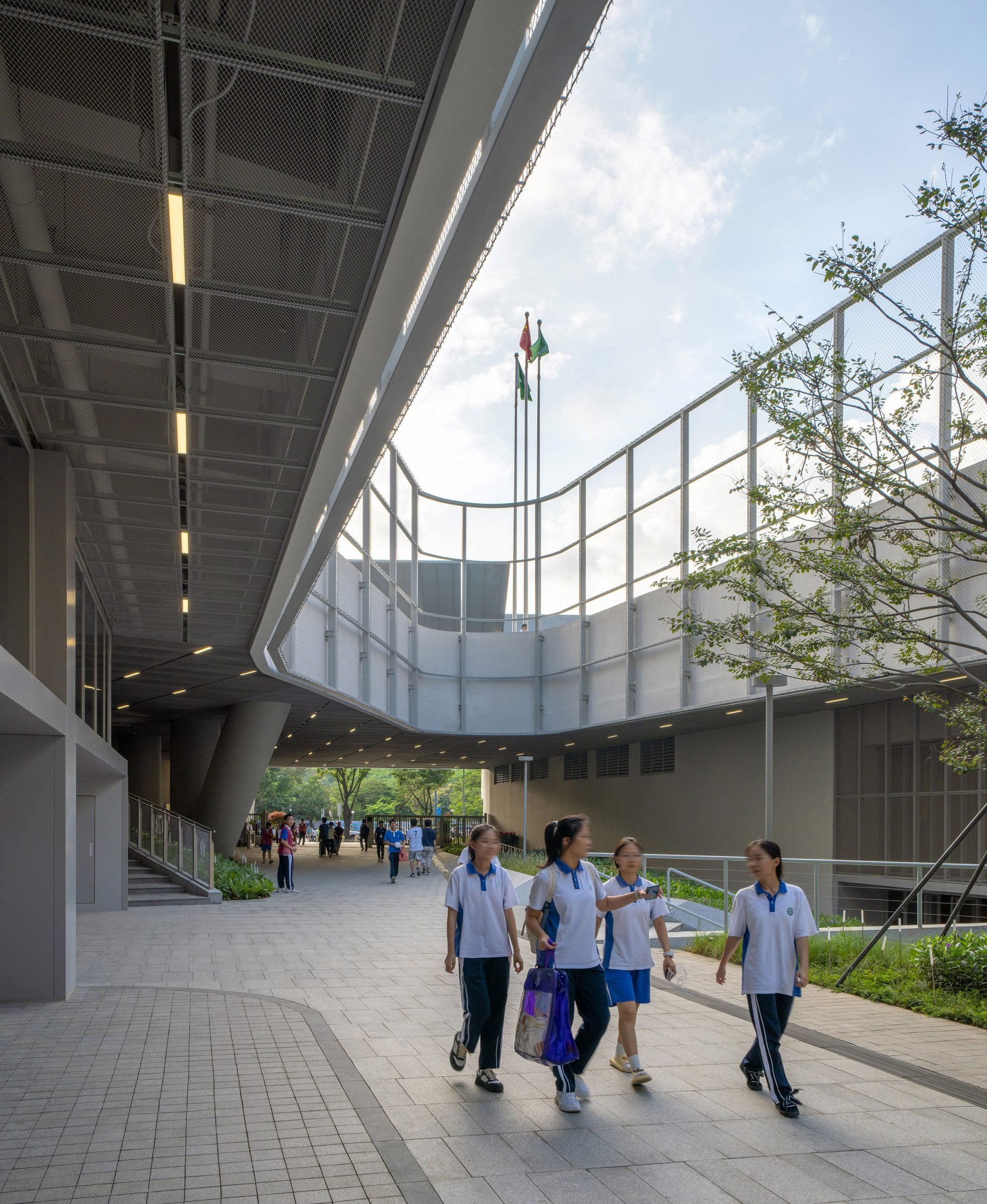 Children walking at Futian High School Campus by Remix Studio