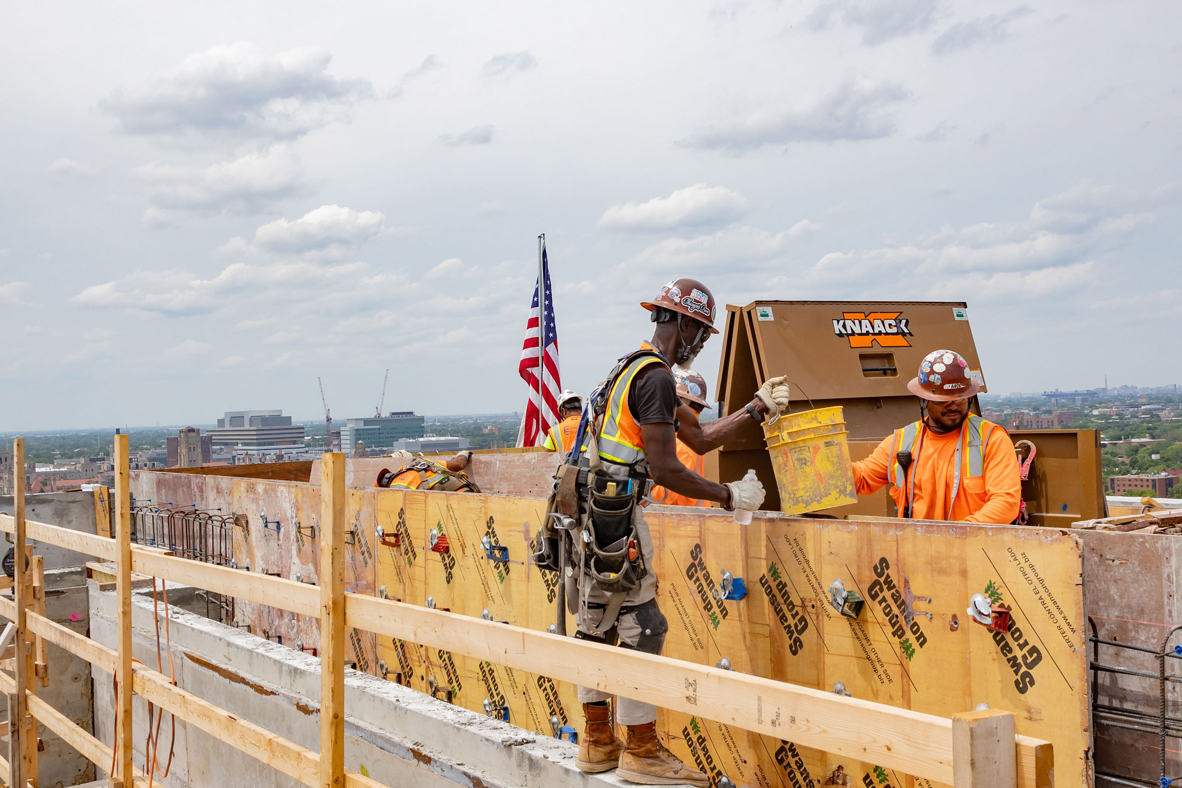 Construction workers up on beams